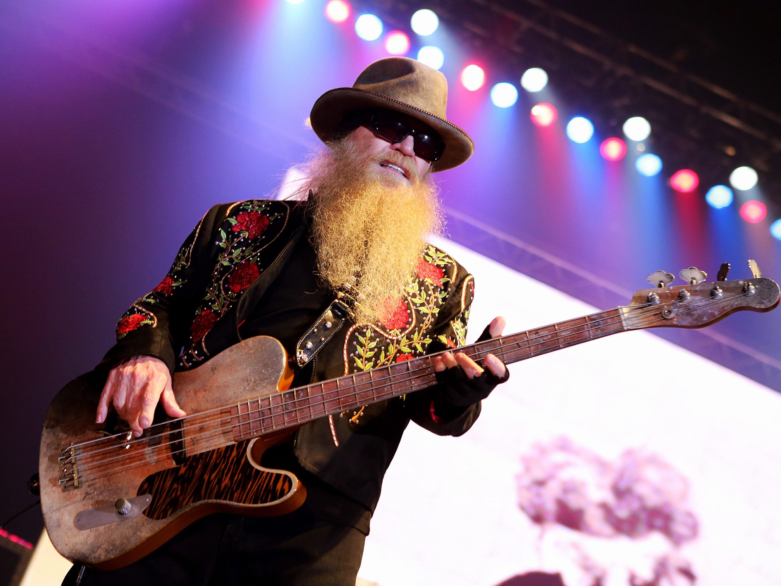 Dusty Hill holding a bass guitar during a performance on stage