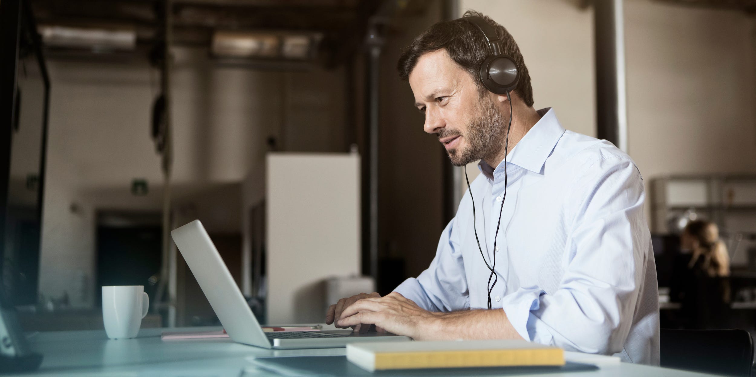 Man on video call on laptop computer with headphones