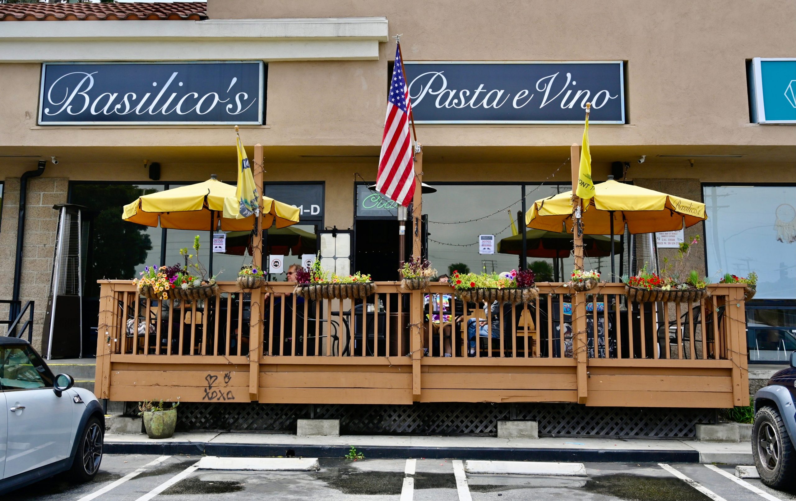 The exterior and porch of Basilico's Pasta e Vino, a restaurant in Huntington Beach California.