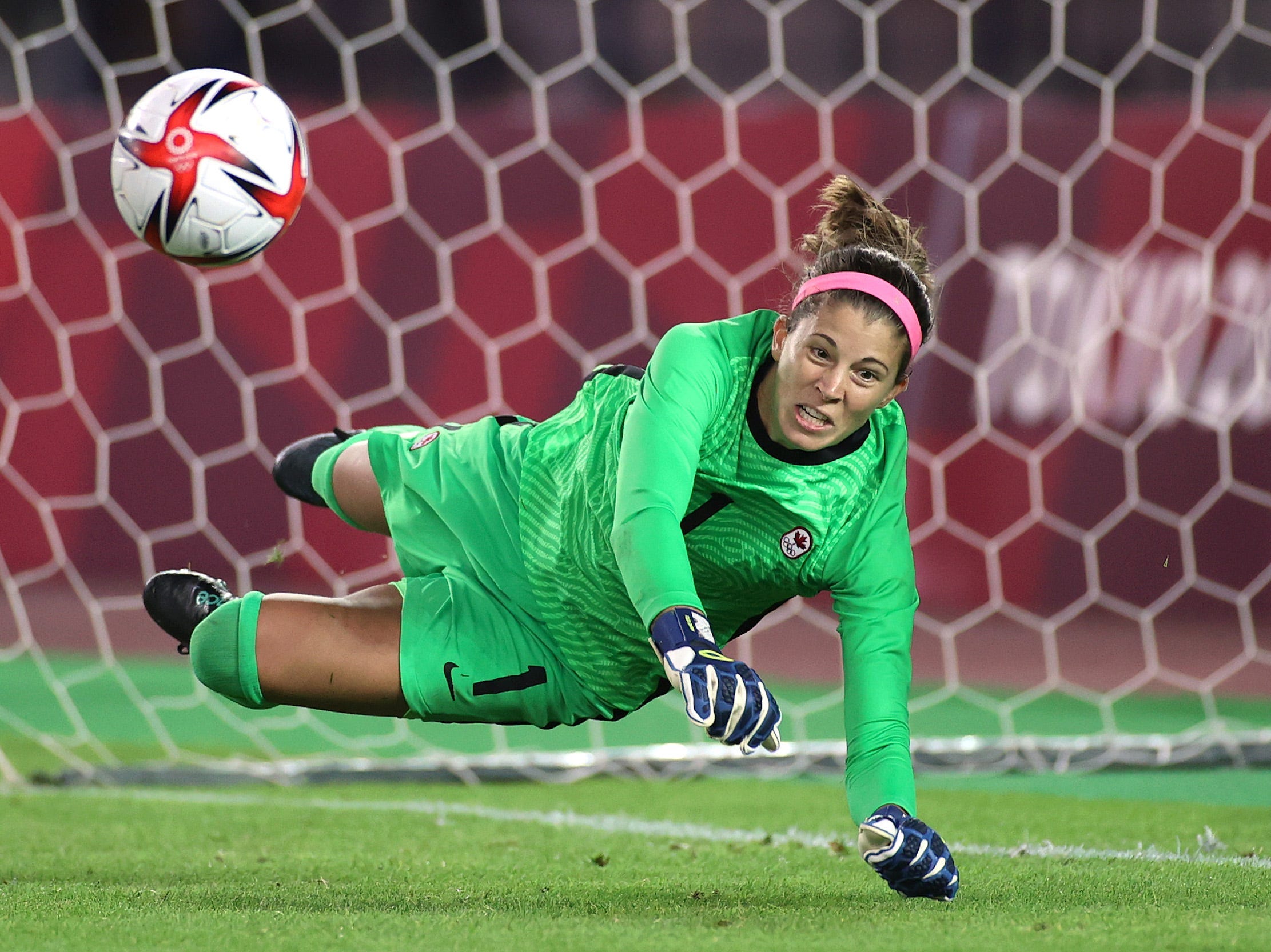Steph Labbe makes a diving save against Brazil during penalty kicks.