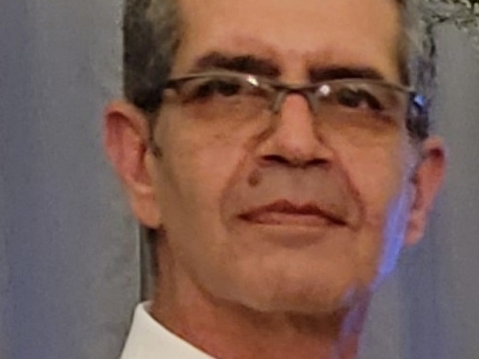 A man with glasses in a shirt and tie