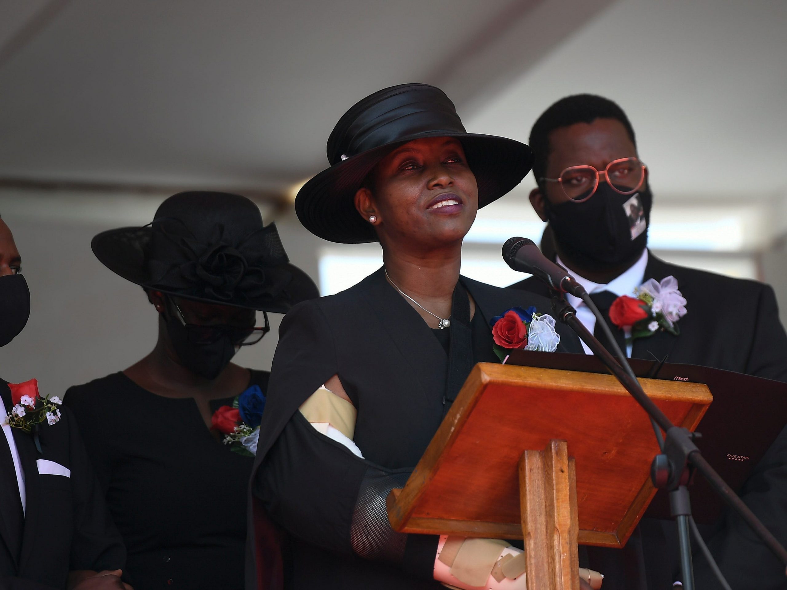 Former first lady of Haiti, Martine Moise, speaks during the funeral of her slain husband, former President Jovenel Moise, accompanied by her children in Cap-Haitien