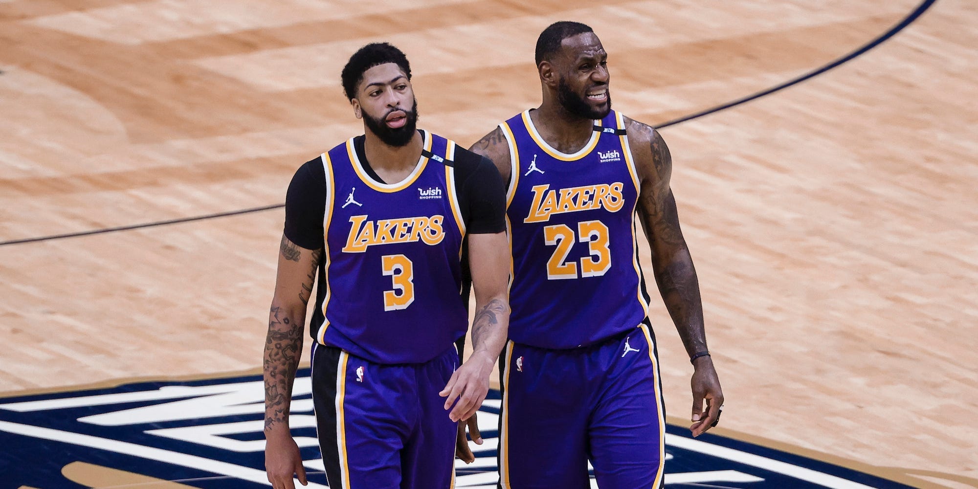 Anthony Davis and LeBron James walk side-by-side during a game.