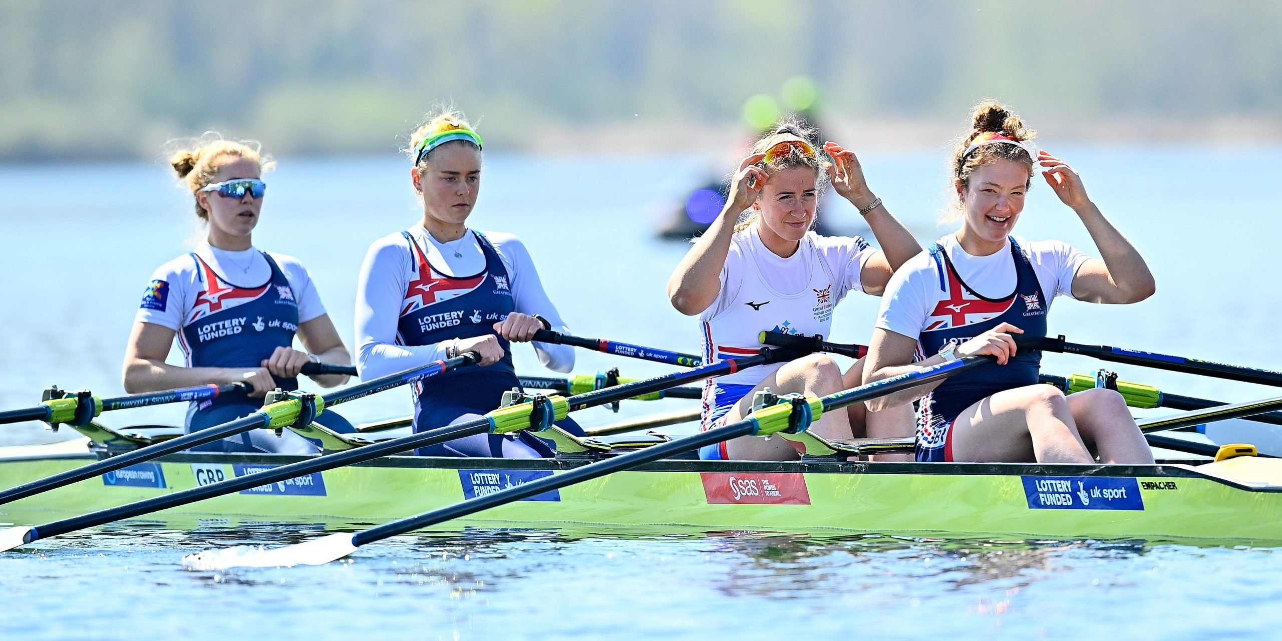 Members of the Great Britain Rowing Team sit in a boat on the water