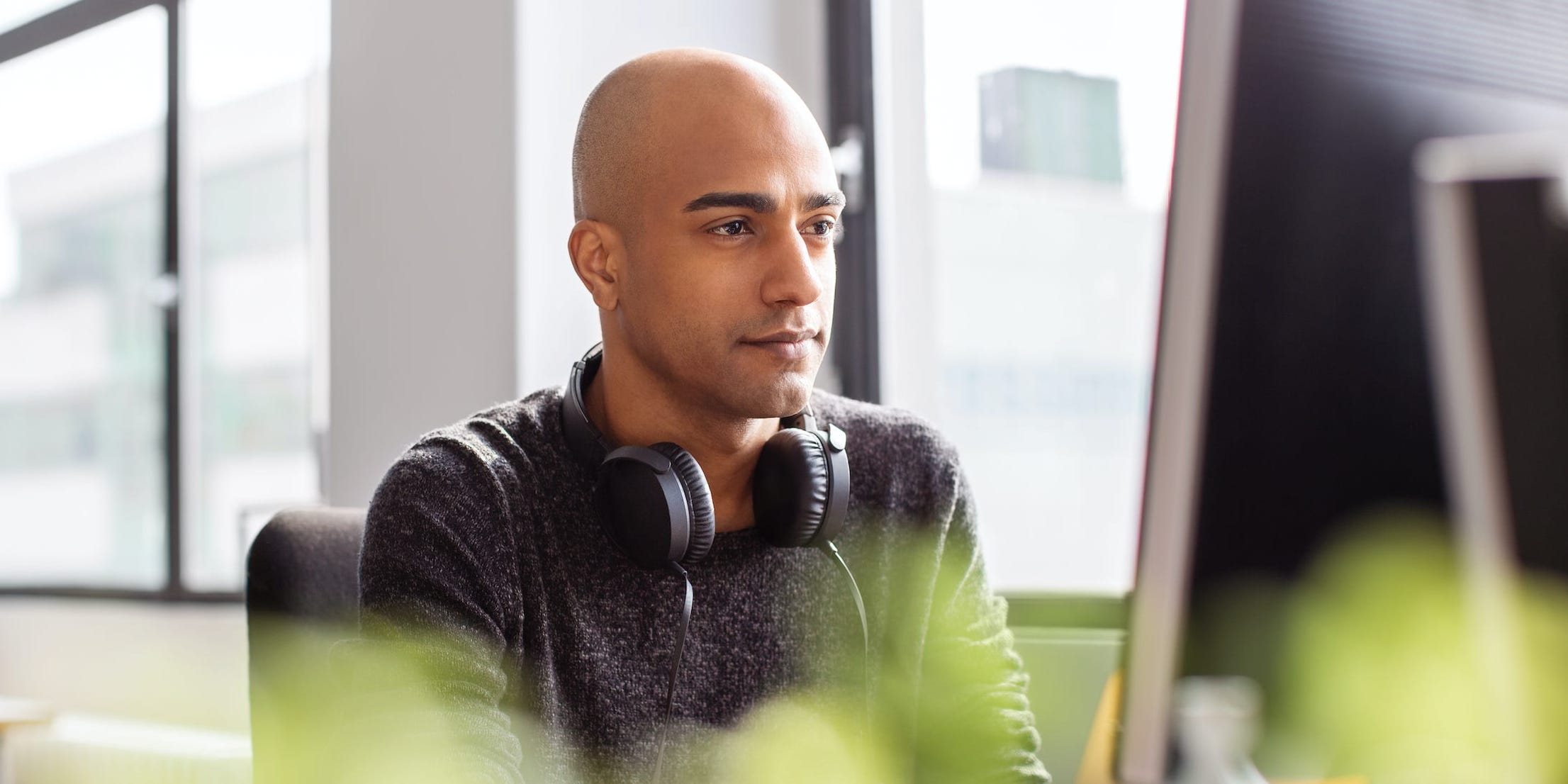 Man in office looking at desktop computer screen