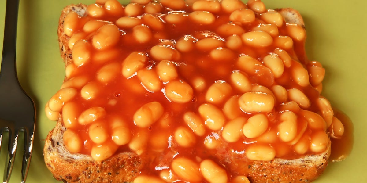 baked beans on toast on a green plate