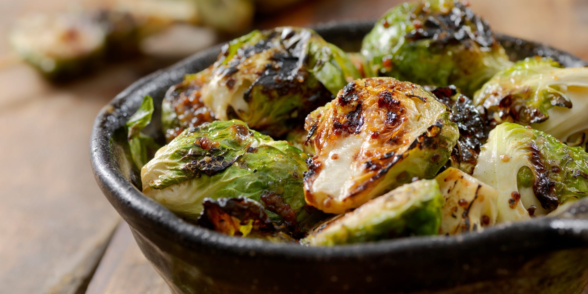 A bowl of glazed grilled Brussels sprouts