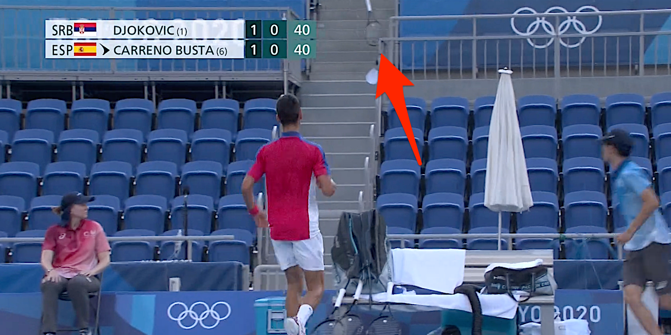 Screenshot shows Novak Djokovic's racket landing in the stands at the Tokyo Olympics.