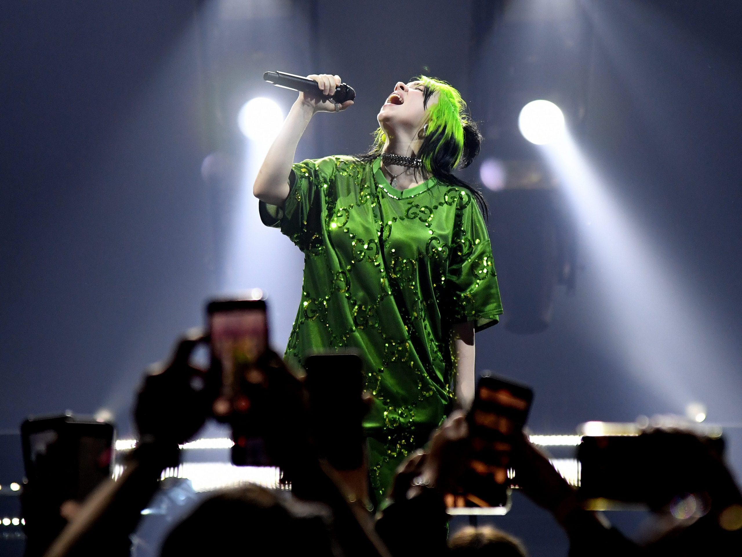 Billie Eilish wears a green shirt as she performs during her Where Do We Go?" World Tour Kick Off - Miami