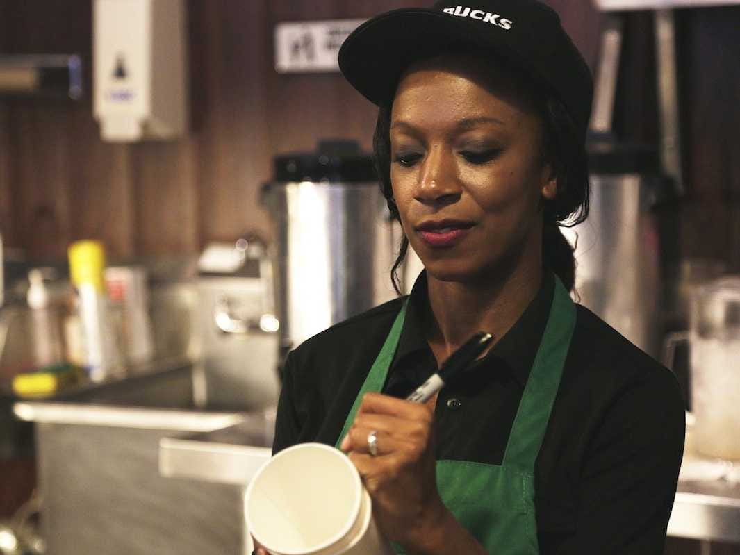 barista writing on coffee