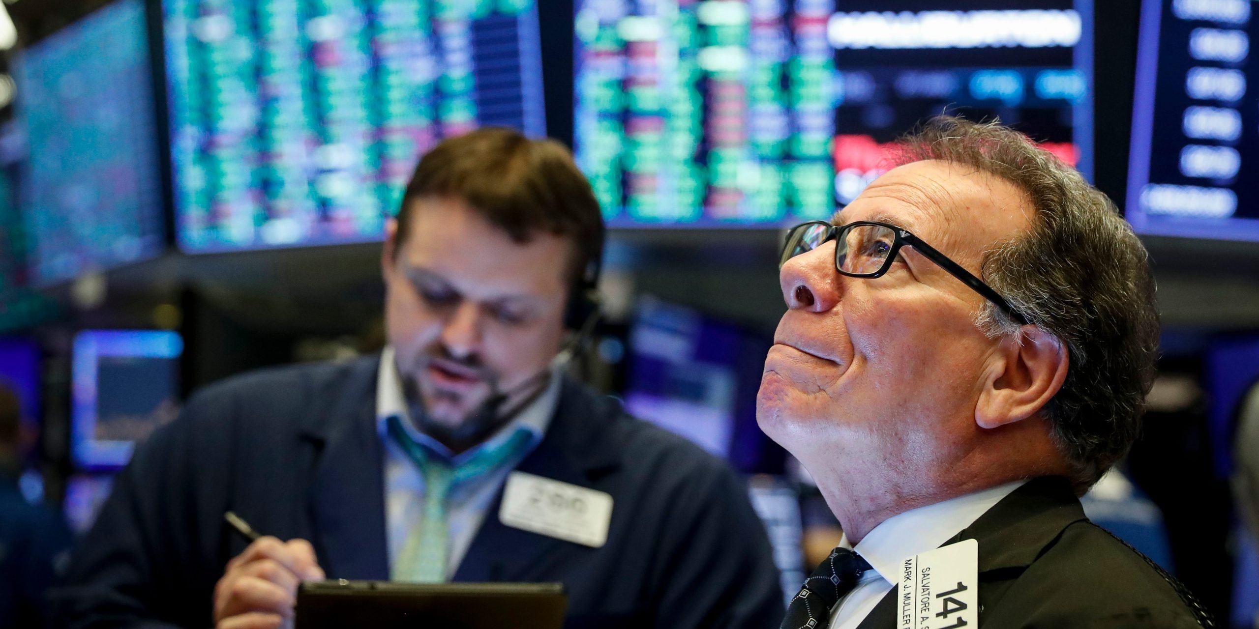 FILE PHOTO: Traders work on the floor of the New York Stock Exchange (NYSE) in New York, U.S., March 20, 2020. REUTERS/Lucas Jackson