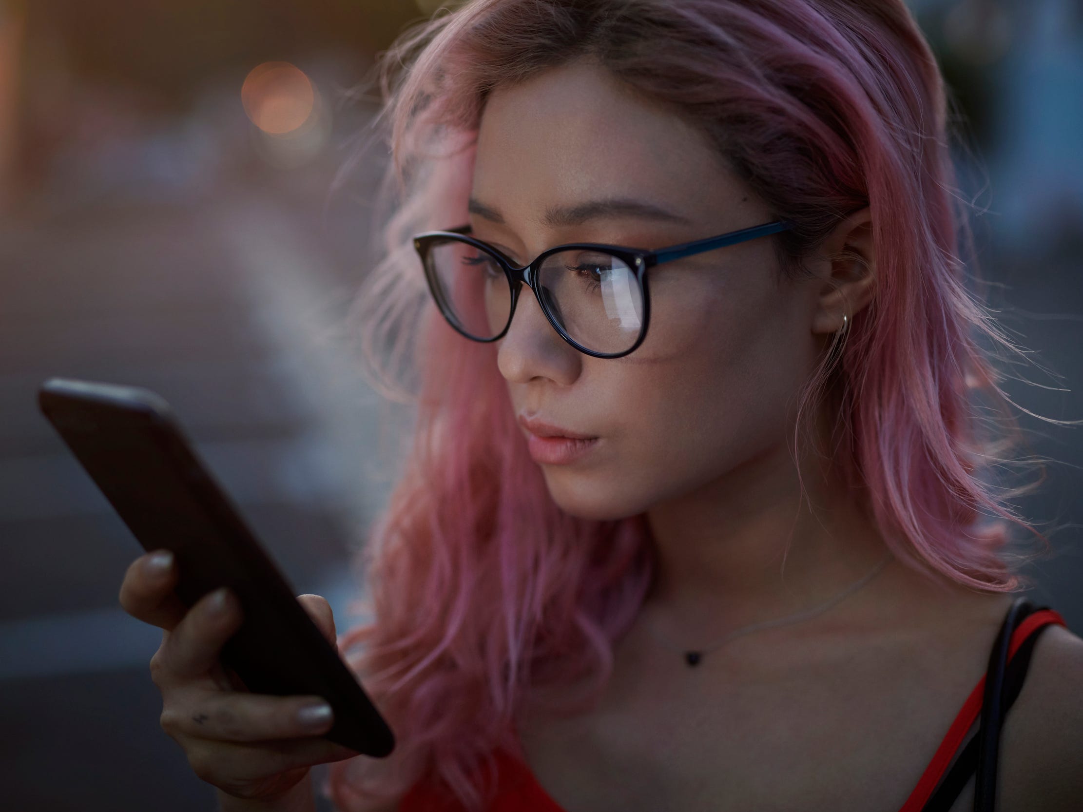 looking at phone texting outside night