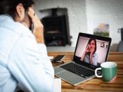 A man (working from home) using a laptop, in an online meeting with a woman, feeling mental burnout.