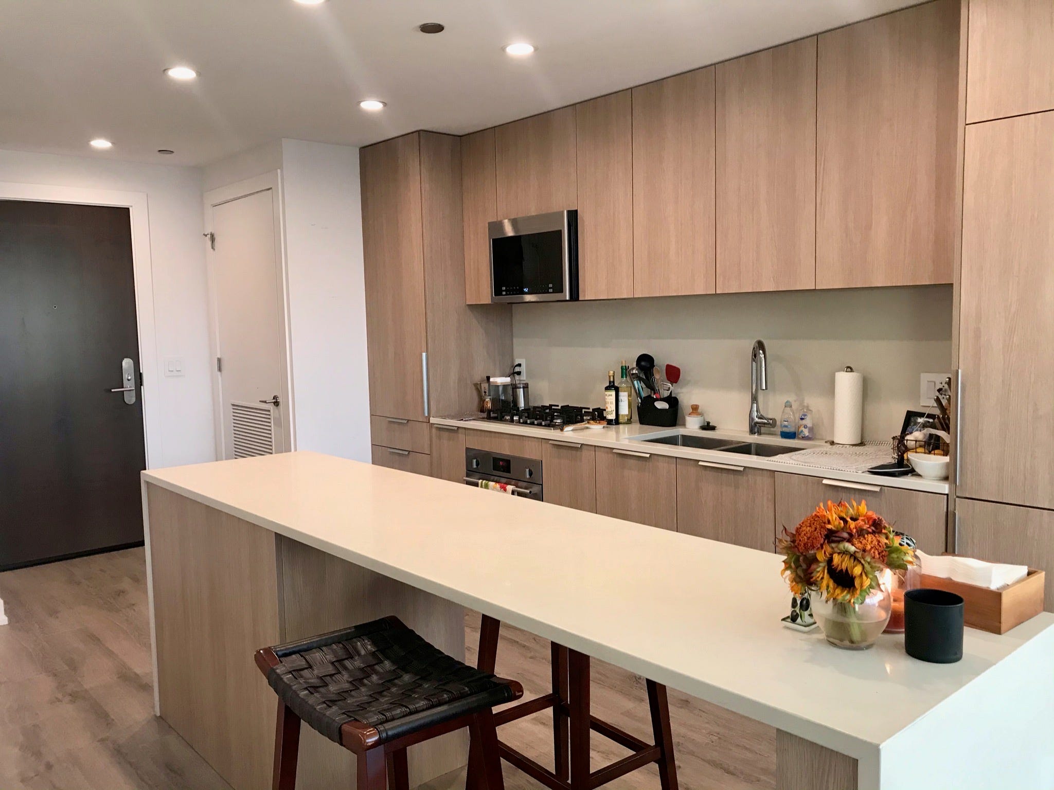 The writer's cabinet and kitchen island with dark stools.