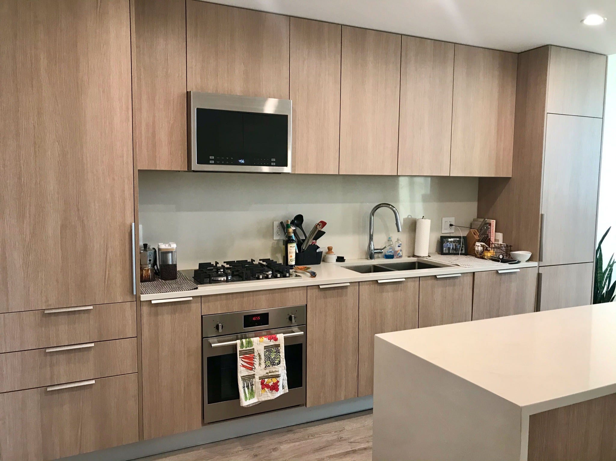 The writer's modern kitchen with beige cabinets.