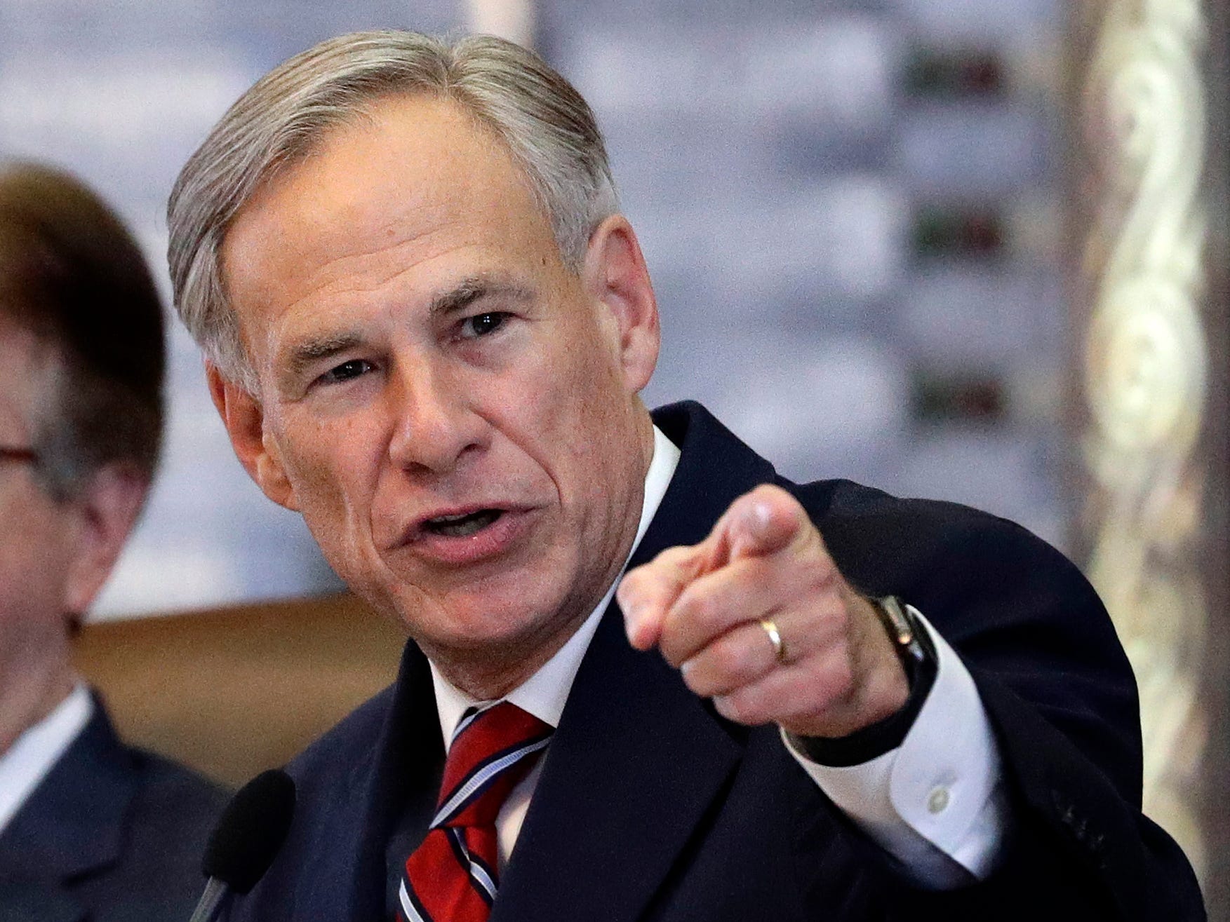 Texas Governor Greg Abbot points at the camera with a stern expression