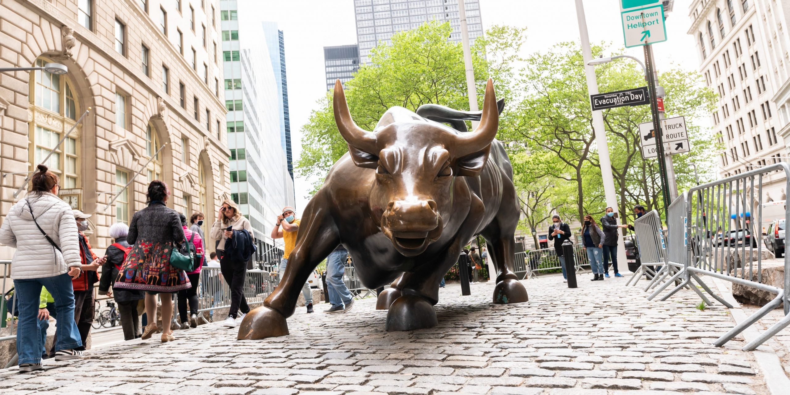 People visit the Charging Bull statue in New York City.