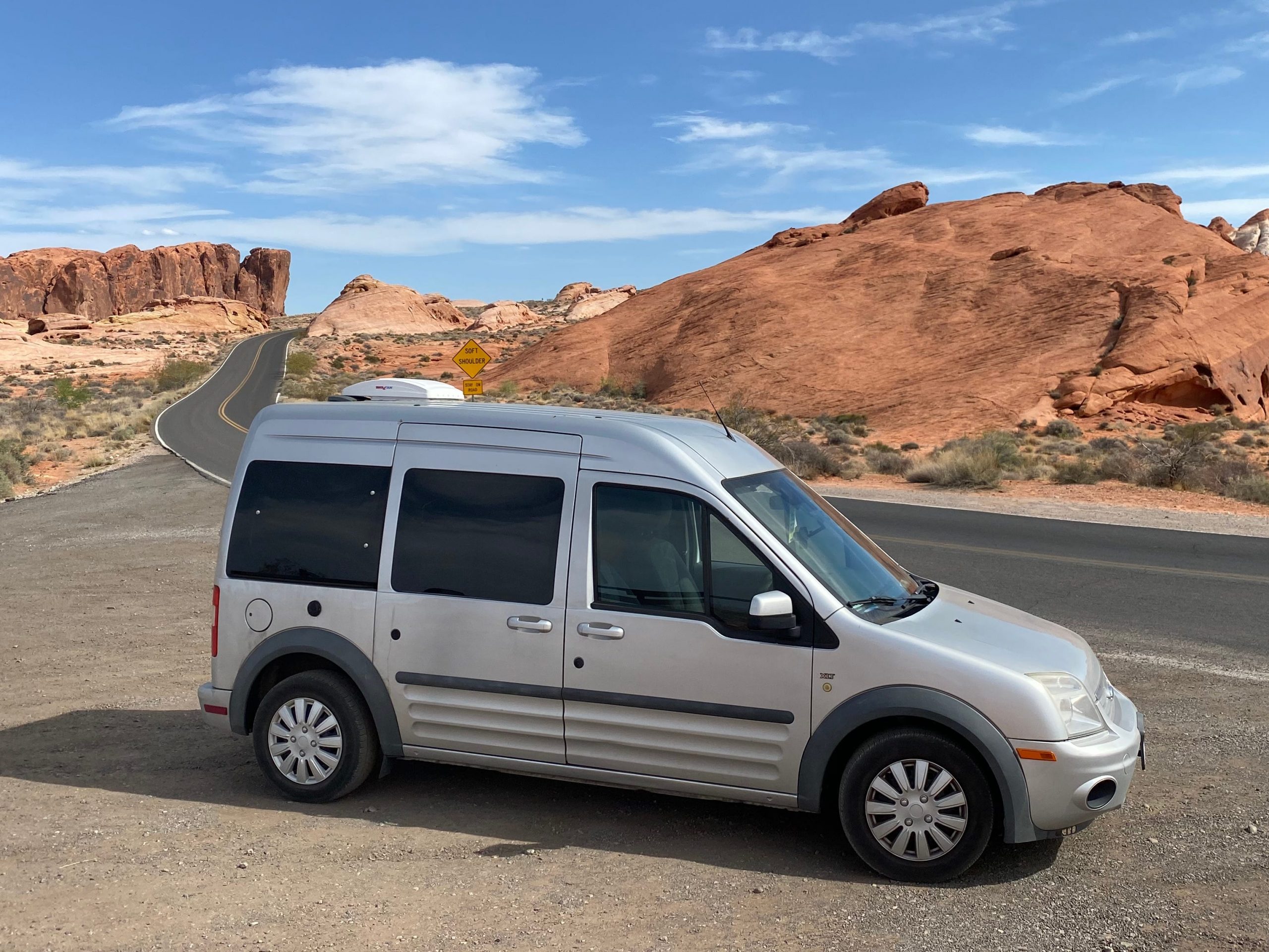 exterior shot of abbey's van in front of some rock structures