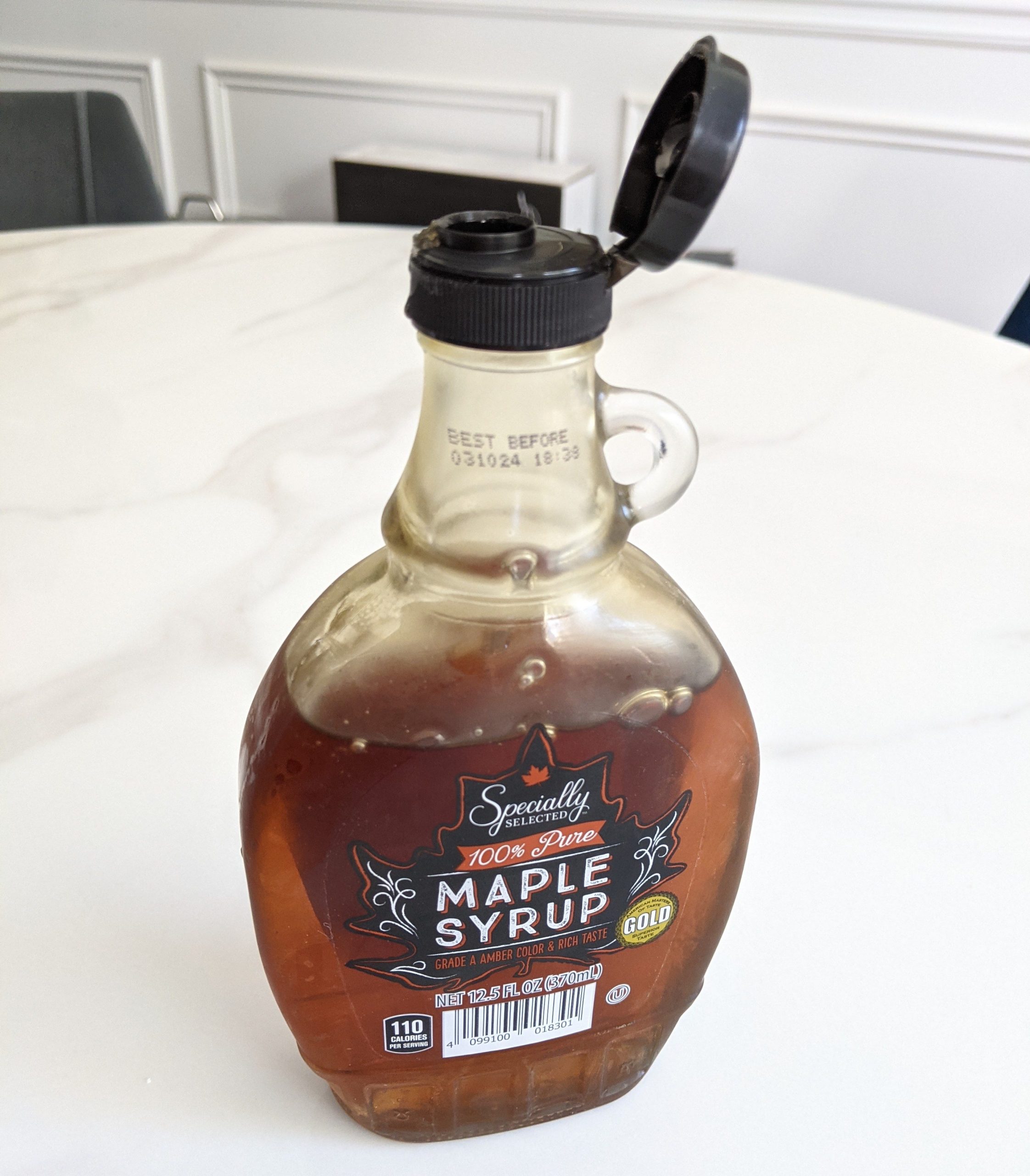 Aldi maple syrup in glass jar on countertop