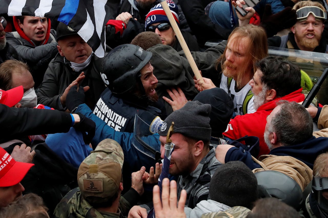 Pro-Trump protesters surround and assault D.C. police officer Michael Fanone during the Capitol riot on Jan. 6, 2021.
