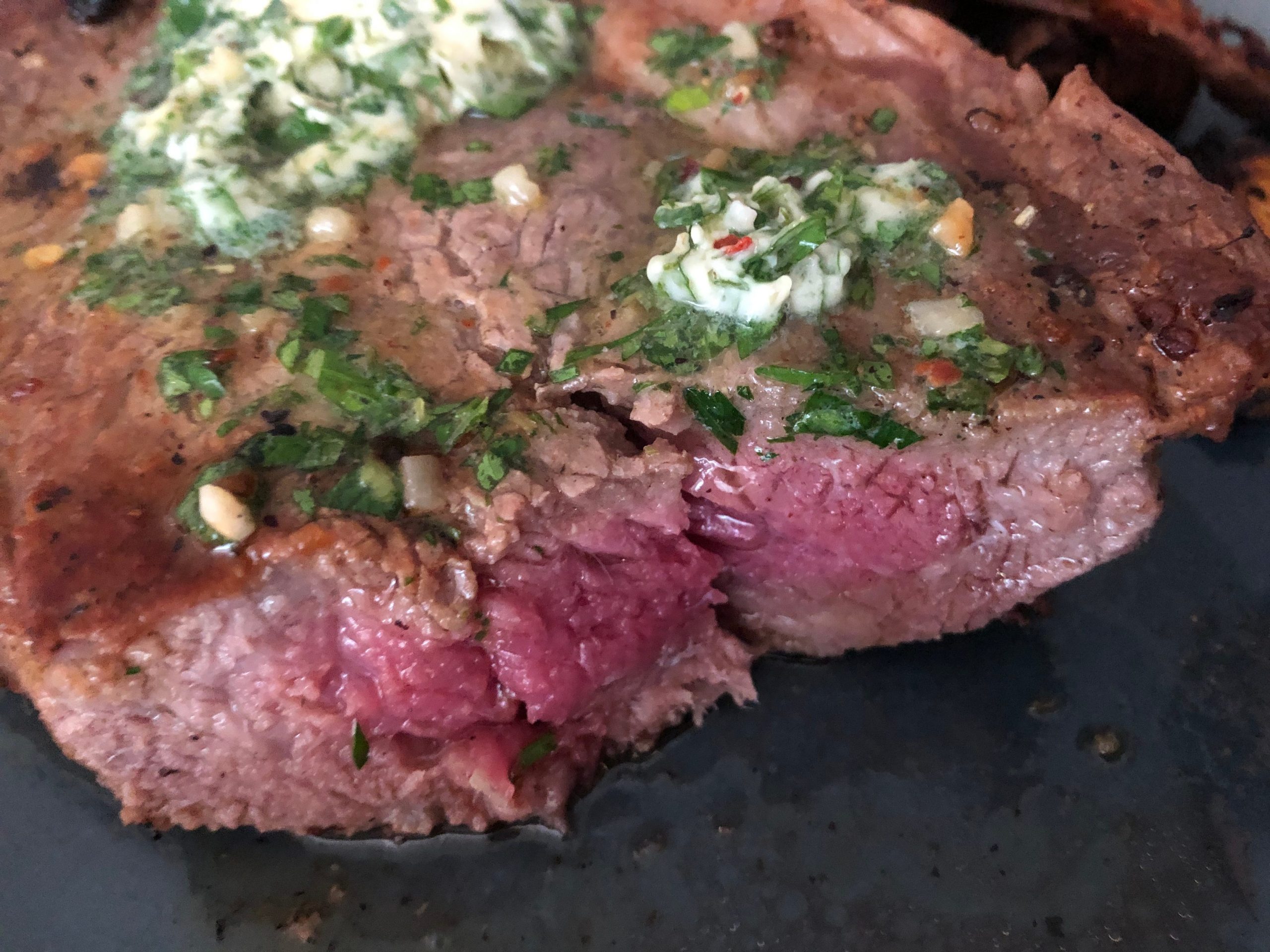 Herb steak cut in half.