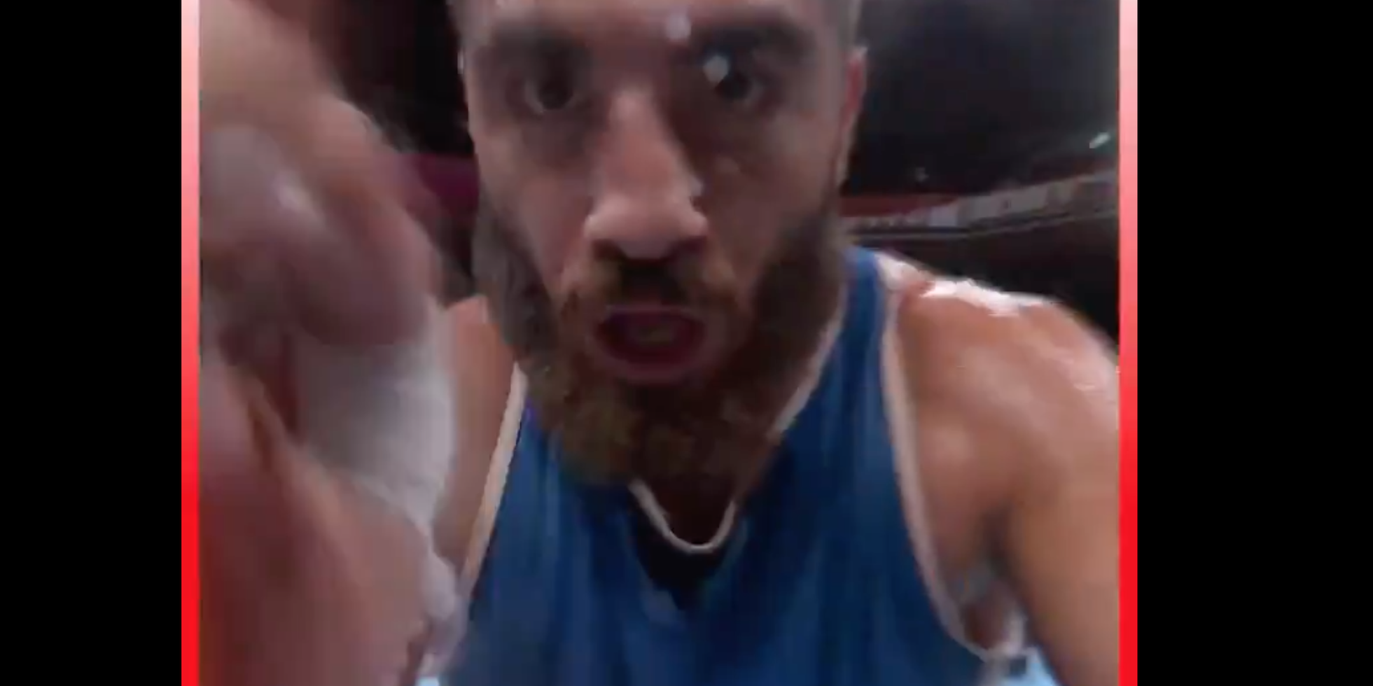 A boxer close to the camera, with one hand raised