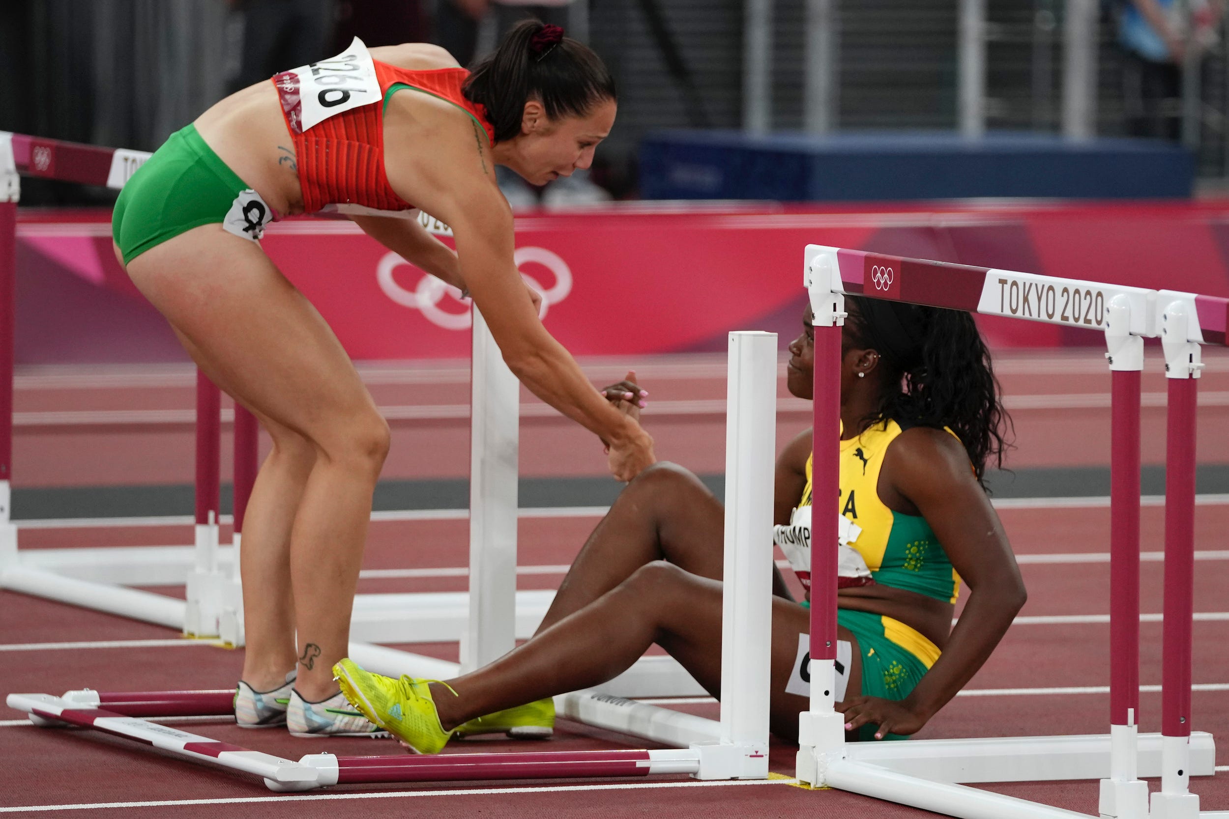 Luza Kozak helps Yunique Thompson to her feet.