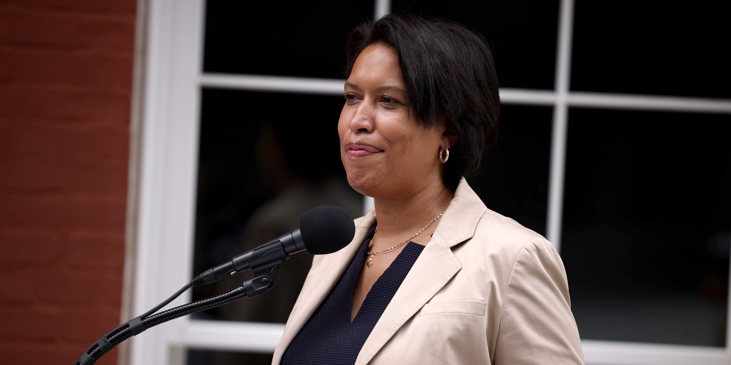 DC Mayor Muriel Bowser stands behind a podium.