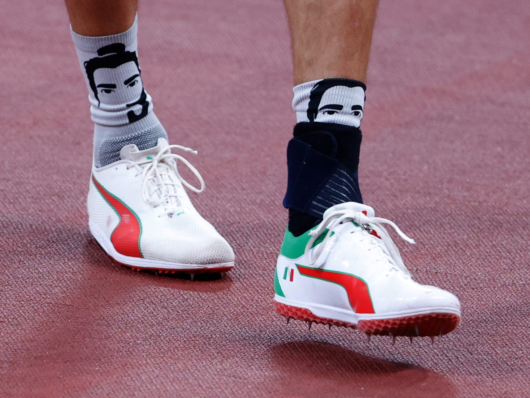 Gianmarco Tamberi wears socks with his face on them.