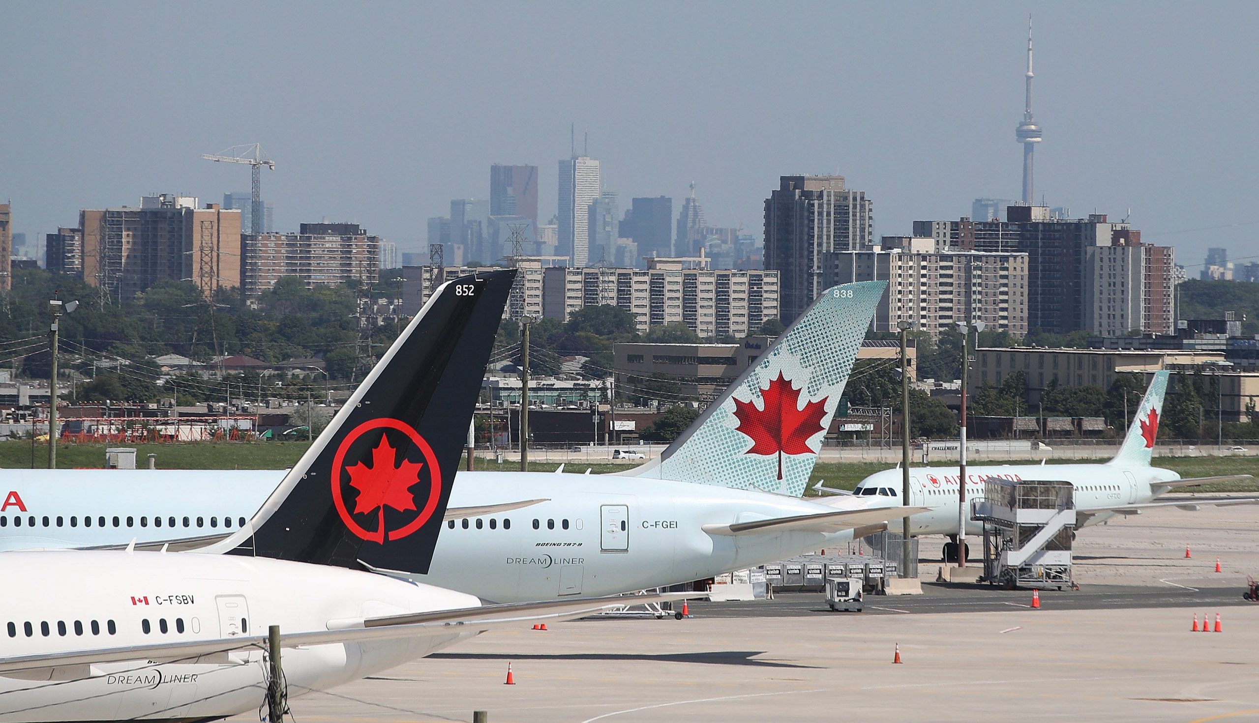 Three planes lined up at airport in Canada during COVID-19 pandemic.