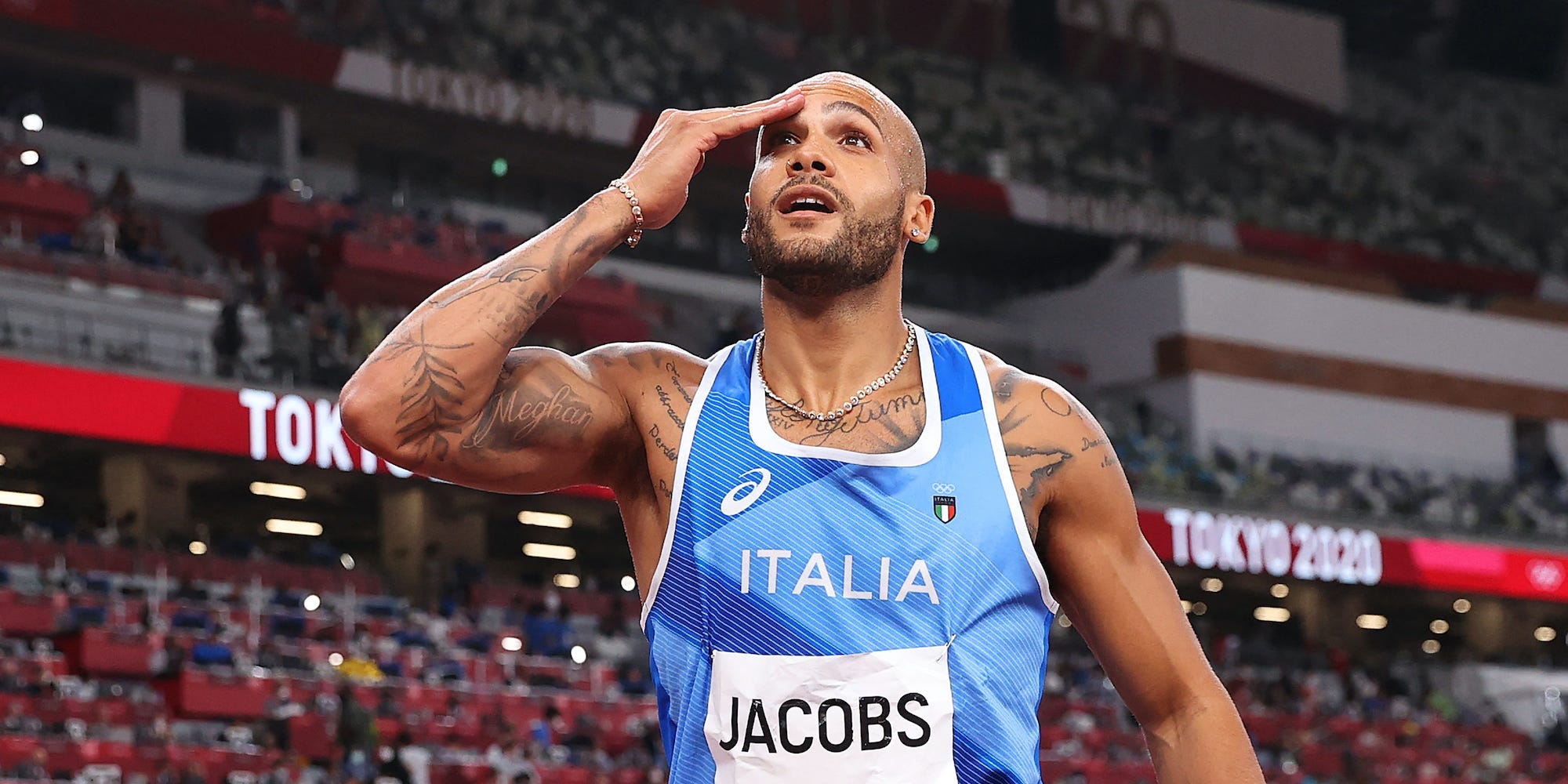 Lamont Marcell Jacobs with his hand on his head after he realized he'd won Olympic gold in the 100-meter final.