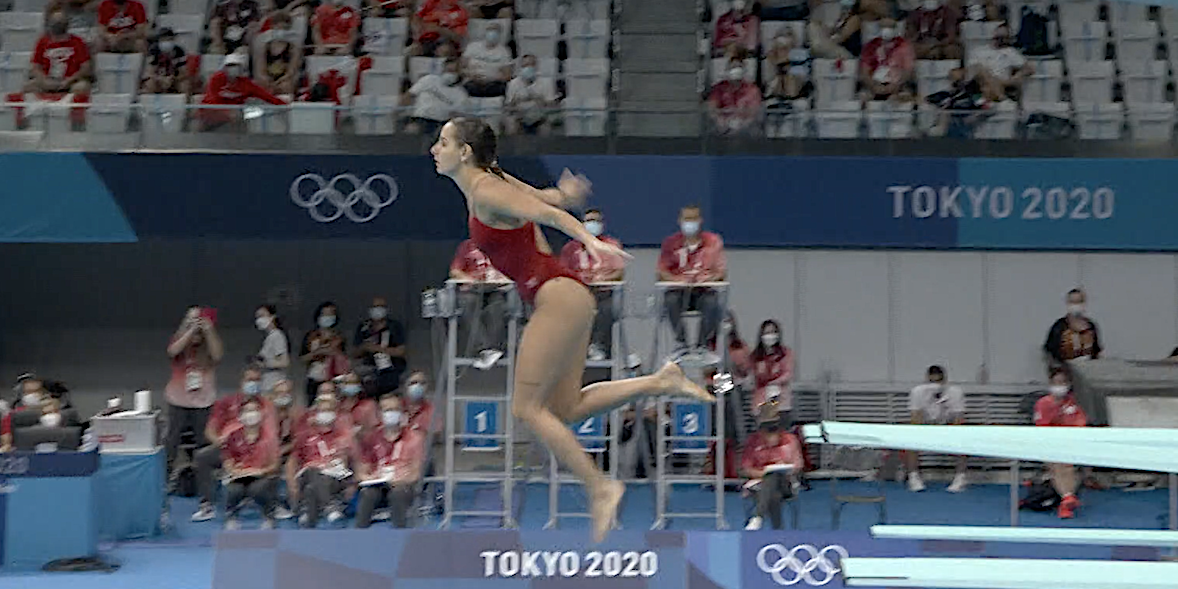 Screenshot shows Pamela Ware vertical in the air on a dive attempt at the Tokyo Olympics.