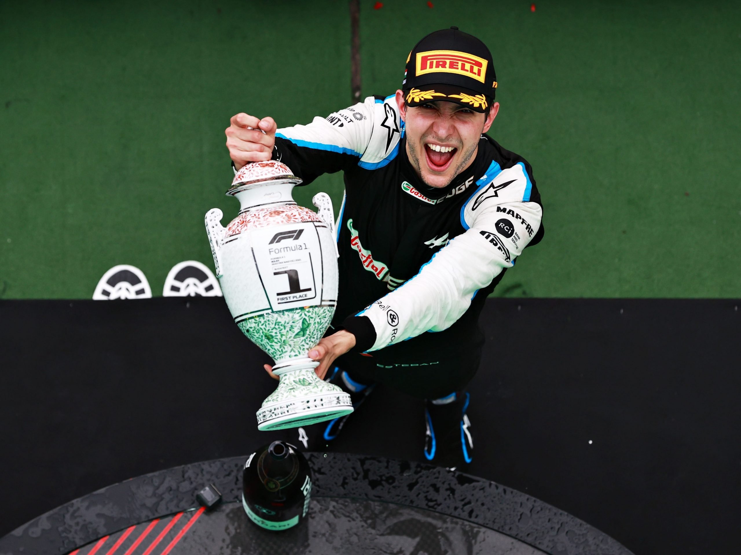 Esteban Ocon holding the trophy after winning the Hungarian Grand Prix