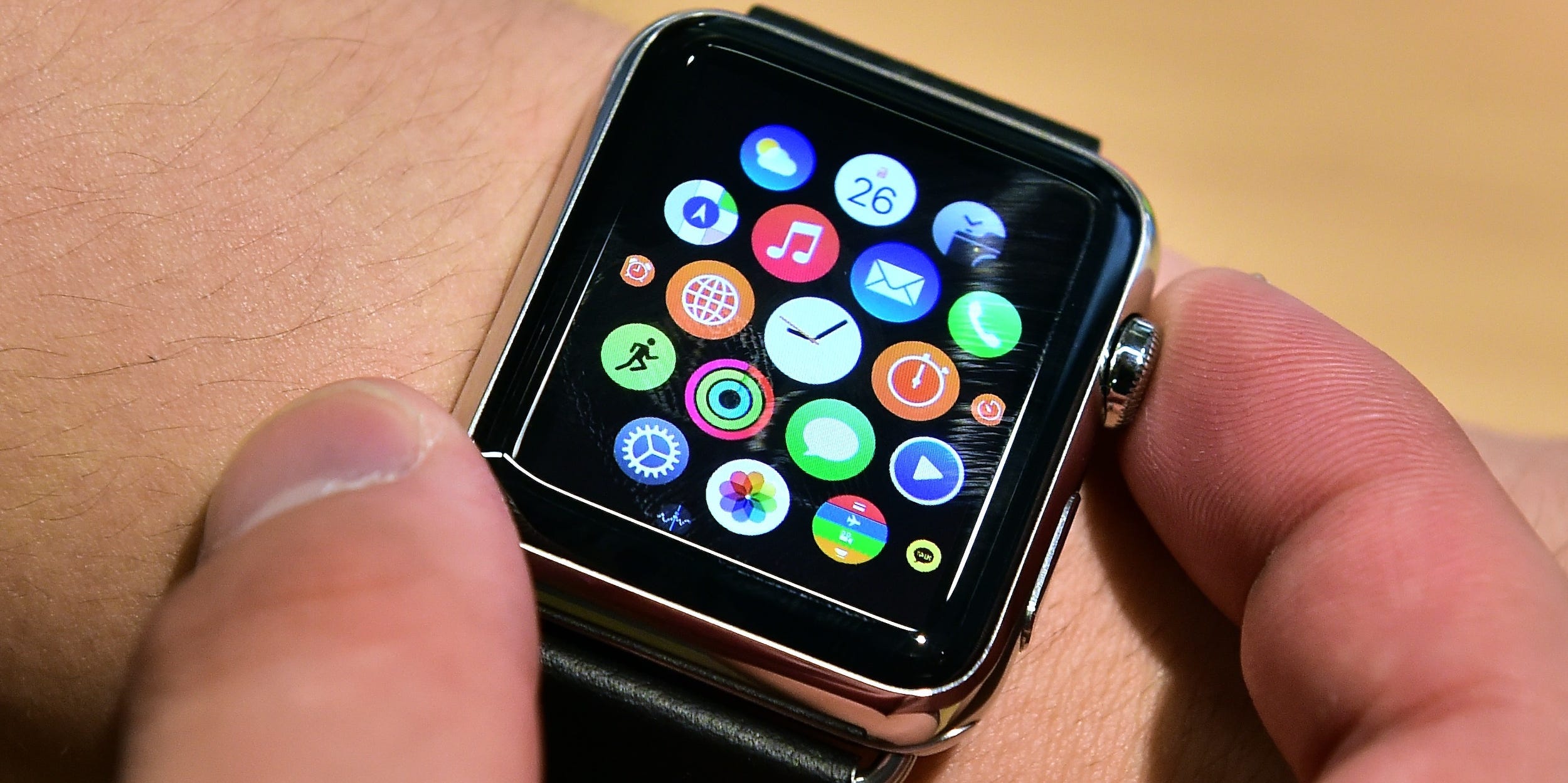 close-up of hands touching apple watch