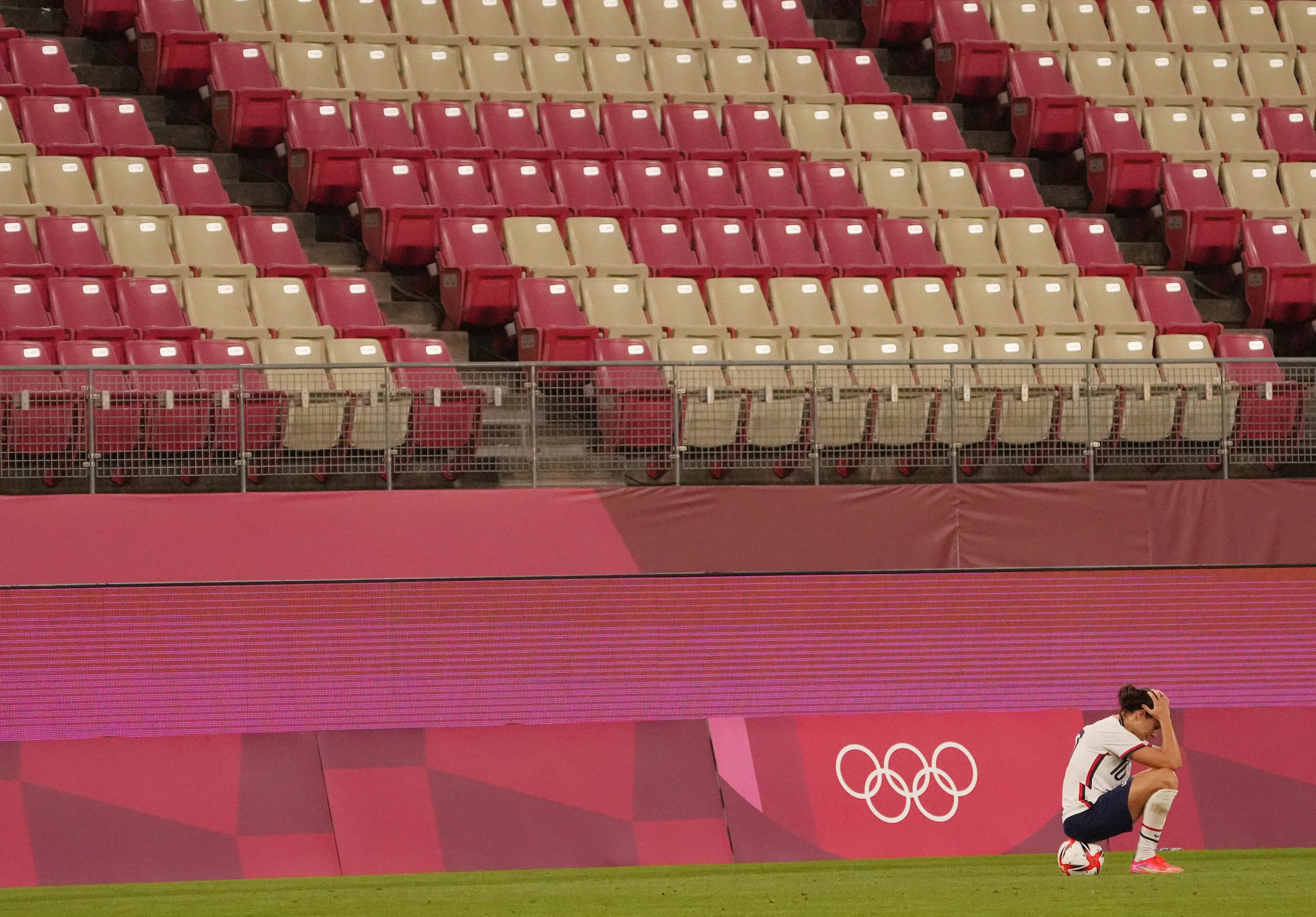Carli Lloyd holds her head in her hands after the USWNT's Olympics loss.