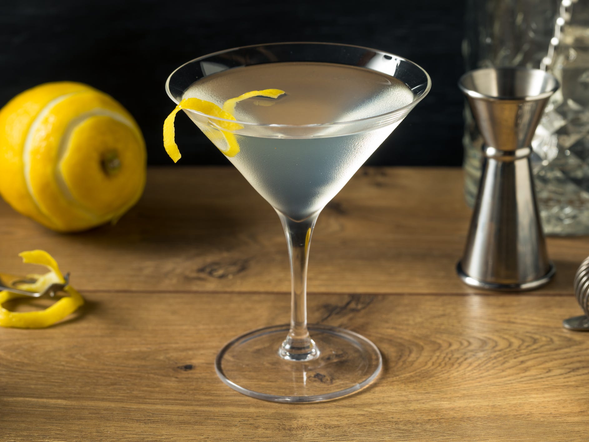 A martini with a twist of lemon peel garnishing the rim