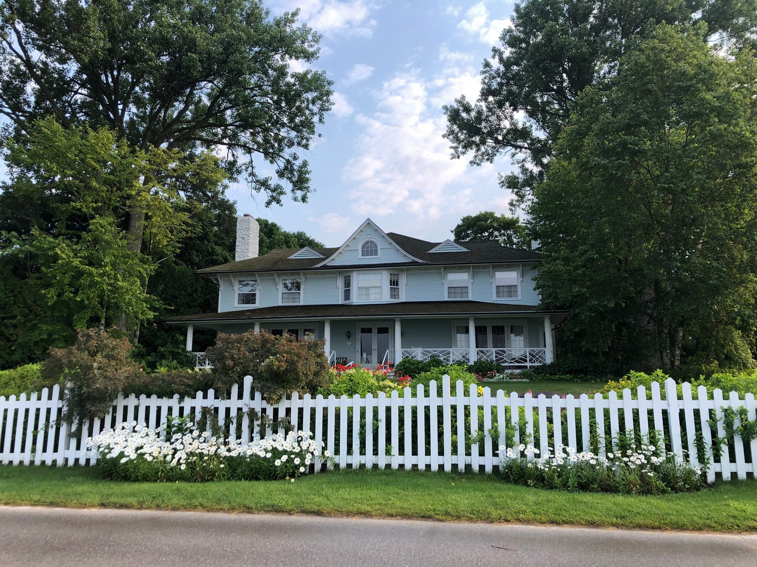 A cottage with a white picket fence on Mackinac Island