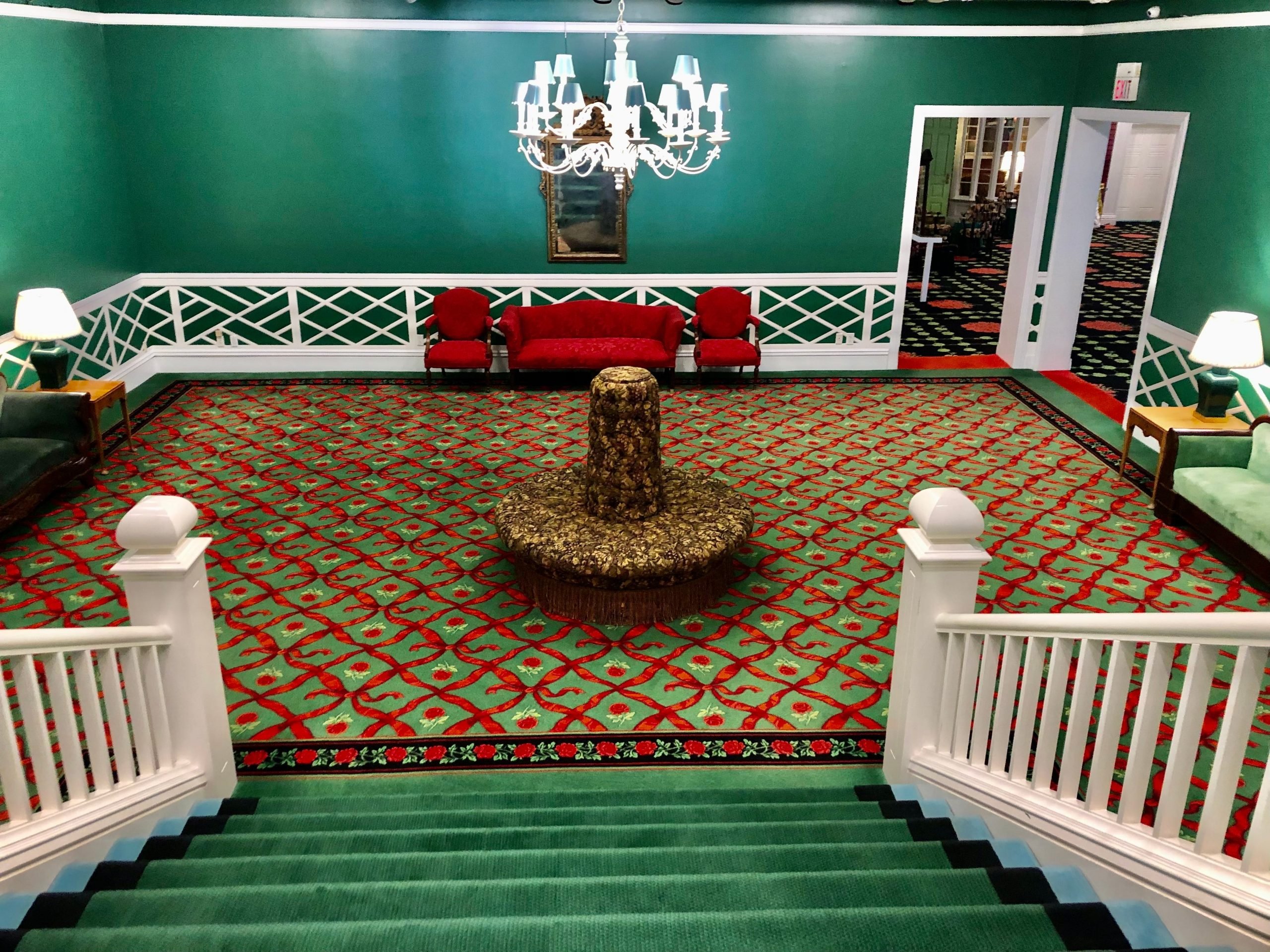 The Grand hotel's downstairs with bring green walls and bright green and red carpets