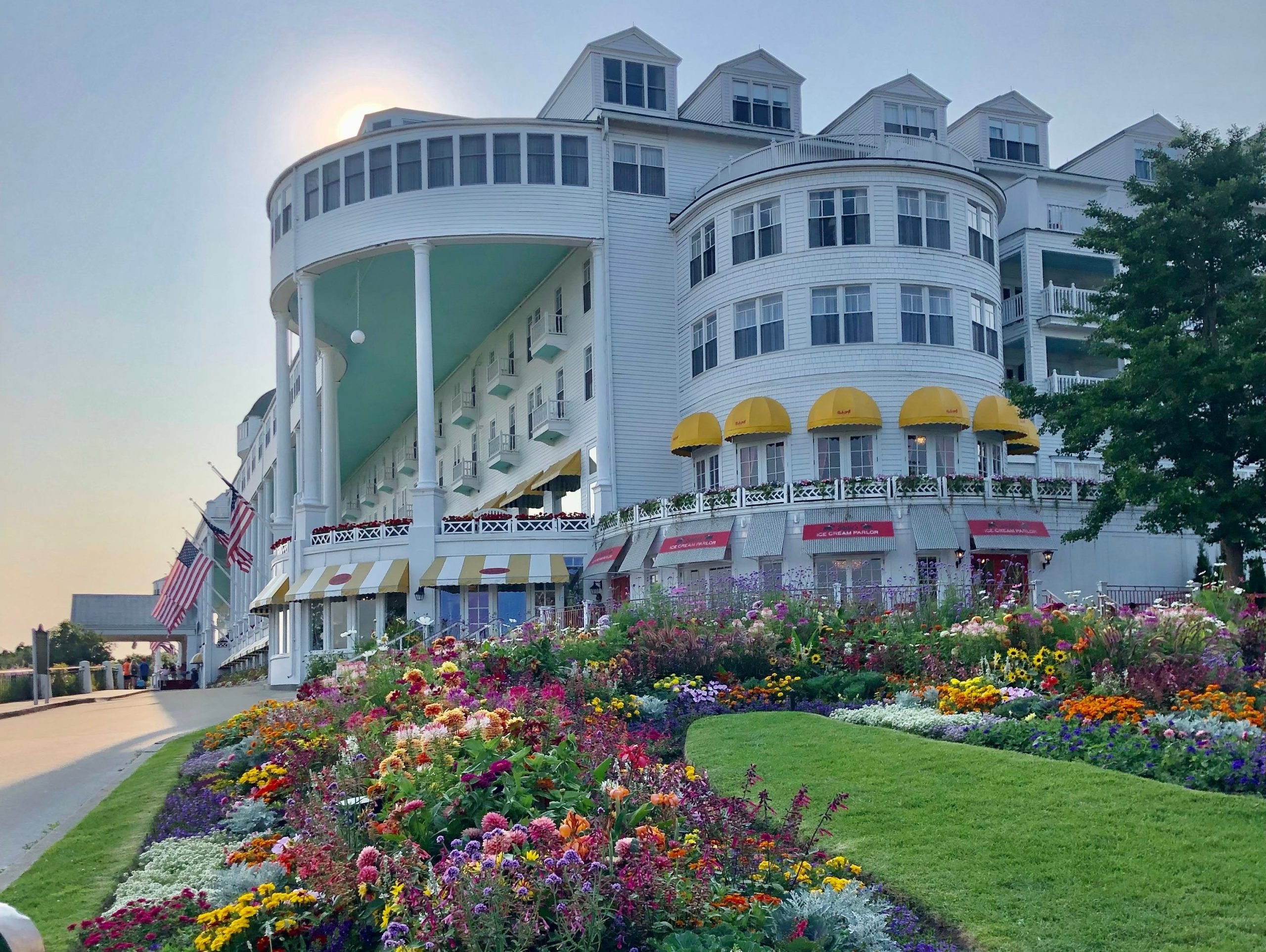 The Grand Hotel Mackinac Island, a white building surrounded by flowers