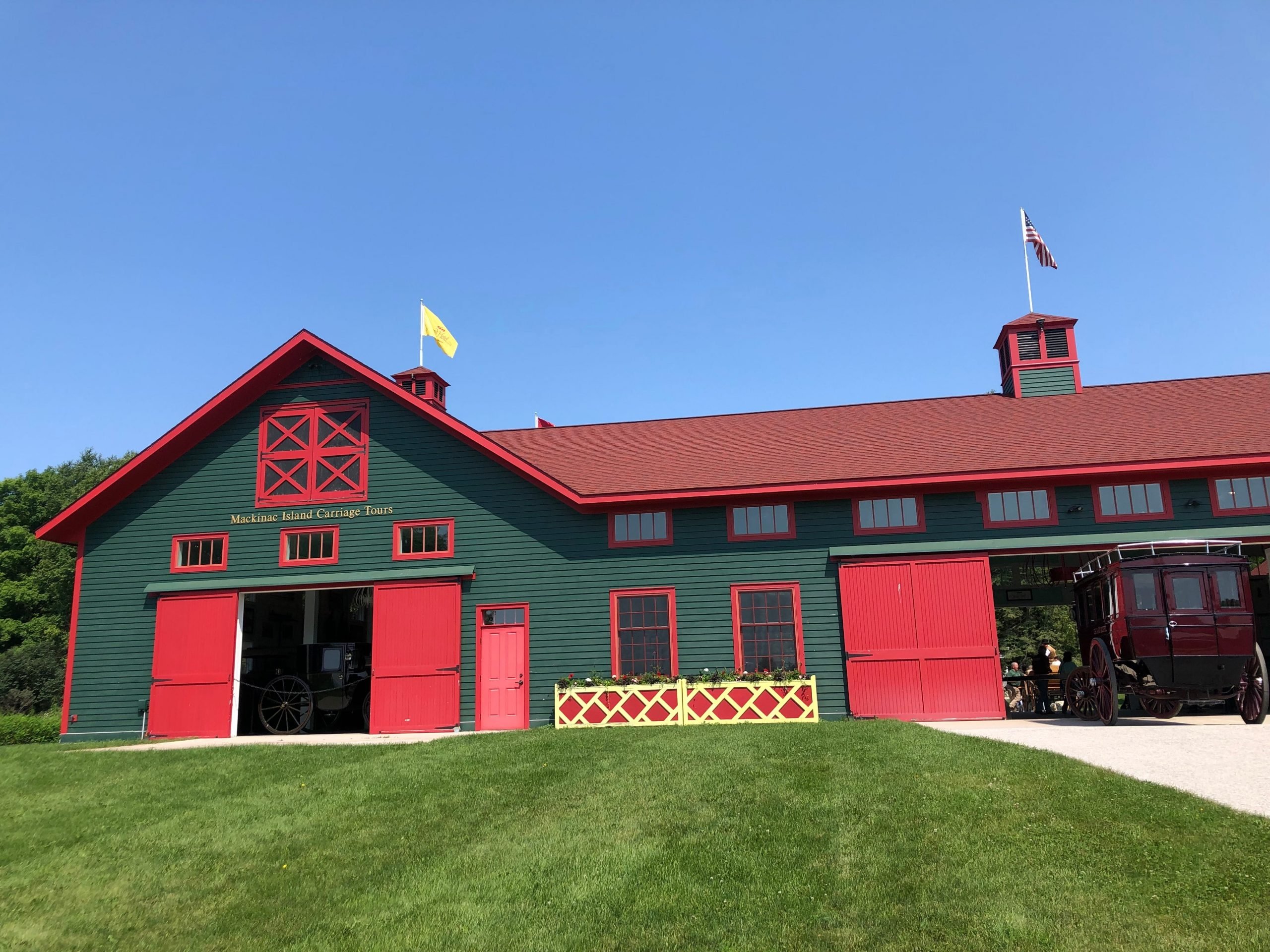 The green and red Grand Stables barn