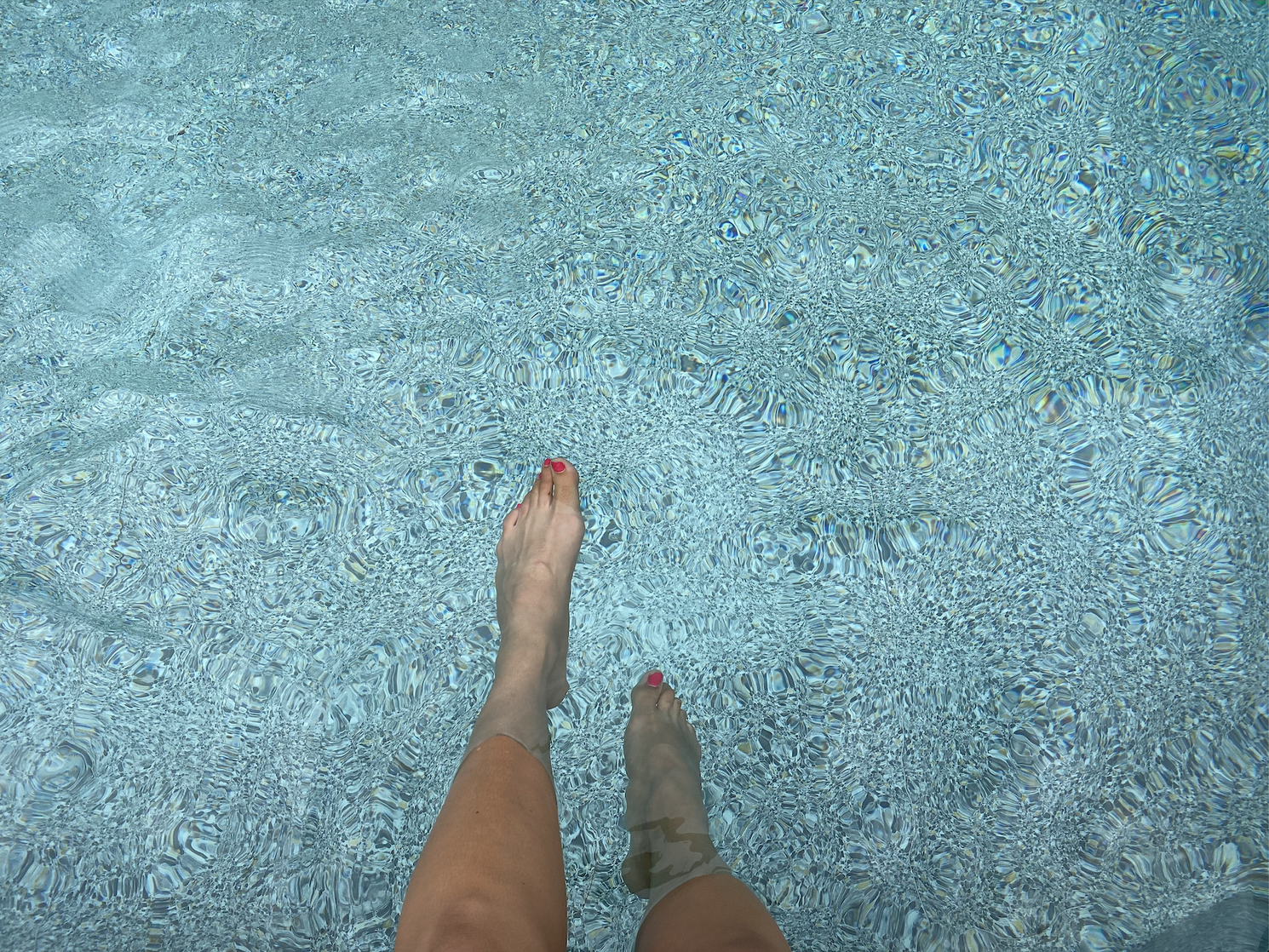 The writer's legs in a pool