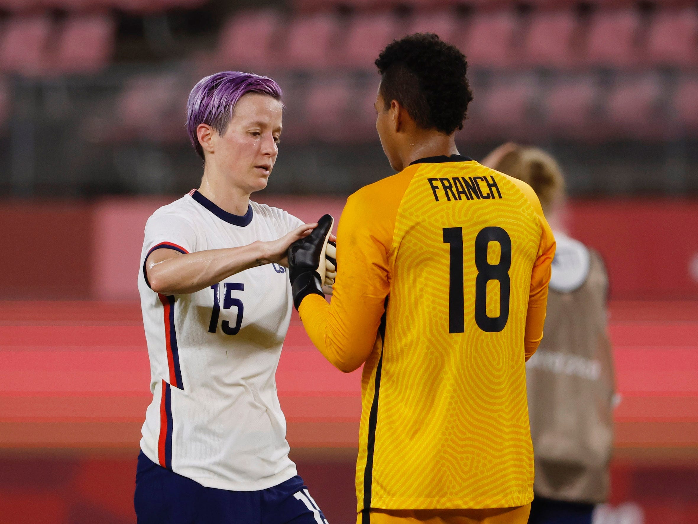 Megan Rapinoe chats with Adrianna Franch (right) after the match.