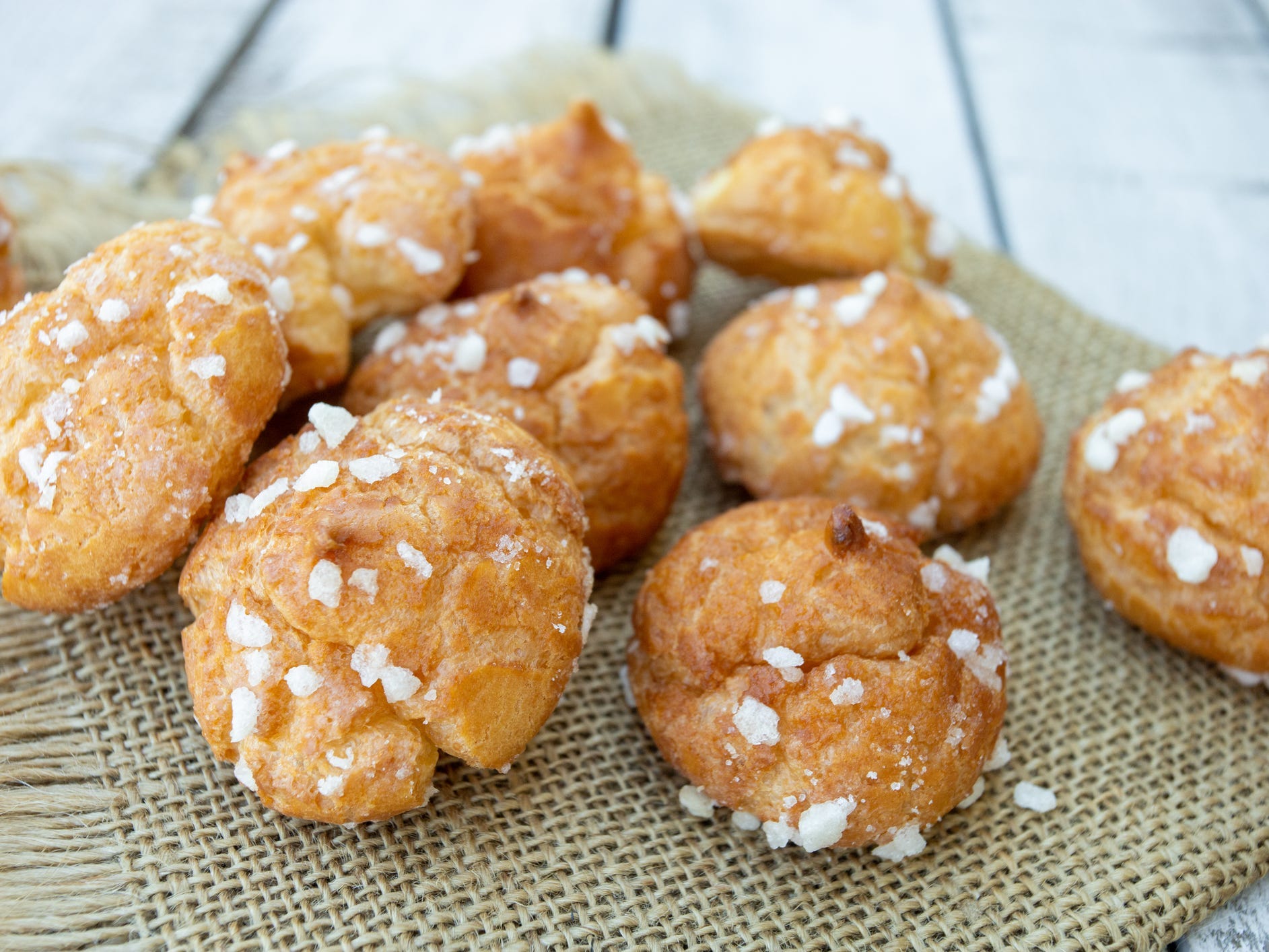 A pile of chouquettes on a table.