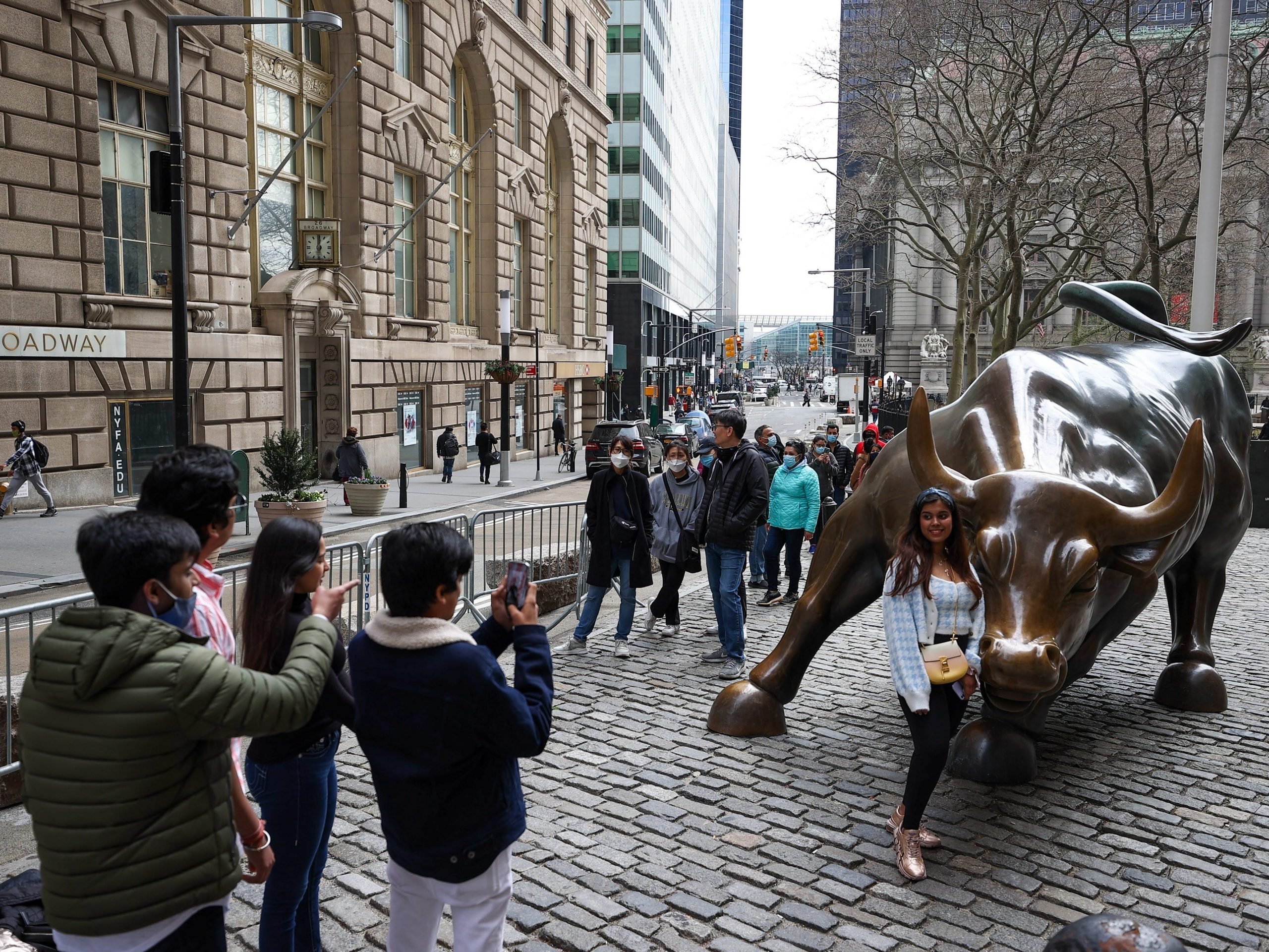 NEW YORK, USA - MARCH 25: Tourists that lined up for take a photo of the Charging Bull are seen during COVID-19 pandemic in New York City, United States on March 25, 2021. (Photo by Tayfun Coskun/Anadolu Agency via Getty Images)