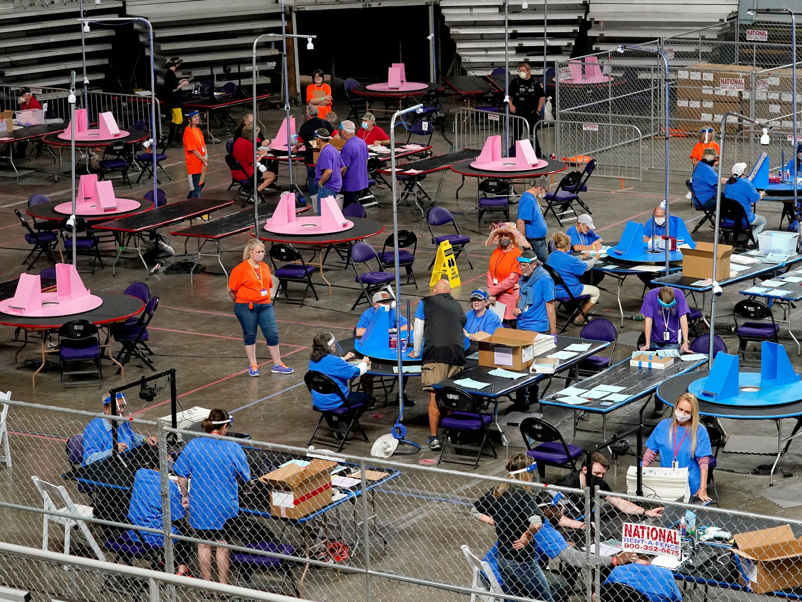 In this May 6, 2021, file photo, Maricopa County ballots cast in the 2020 general election are examined and recounted by contractors working for Florida-based company, Cyber Ninjas at Veterans Memorial Coliseum in Phoenix.