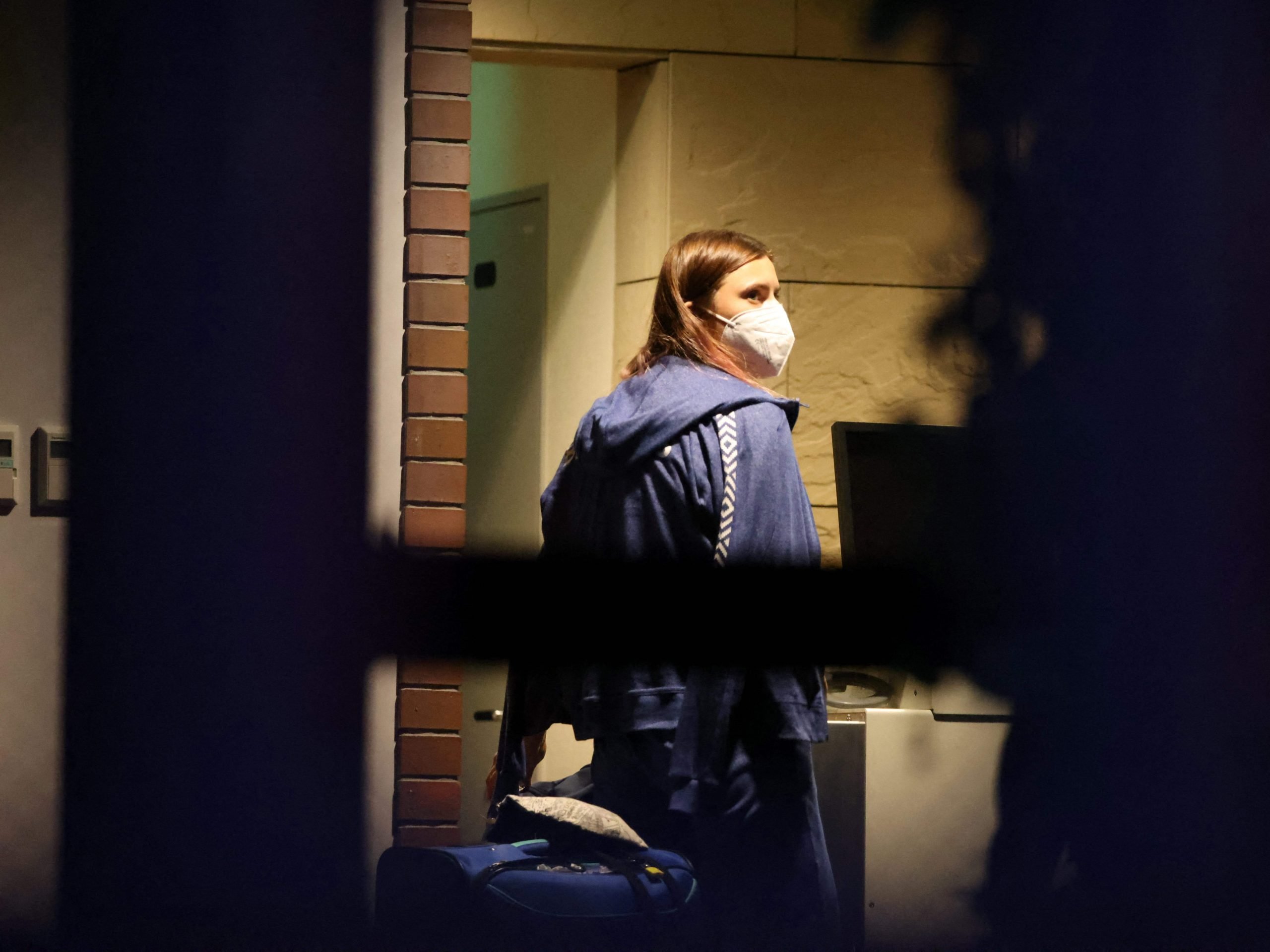 Belarus athlete Krystsina Tsimanouskaya, who claimed her team tried to force her to leave Japan following a row during the Tokyo 2020 Olympic Games, walks with her luggage inside the Polish embassy in Tokyo on August 2, 2021.