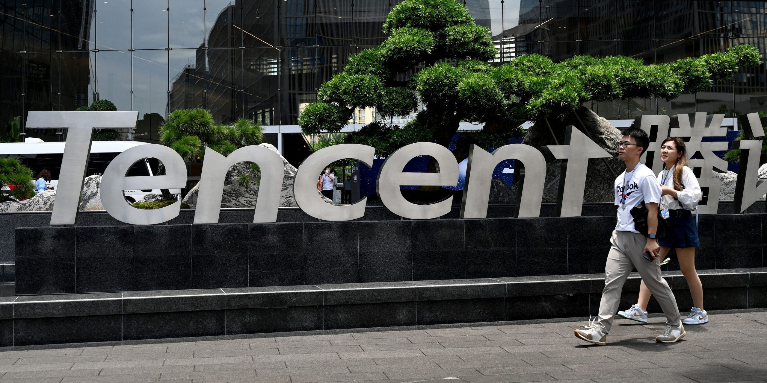 People walking past the Tencent headquarters in the southern Chinese city of Shenzhen.