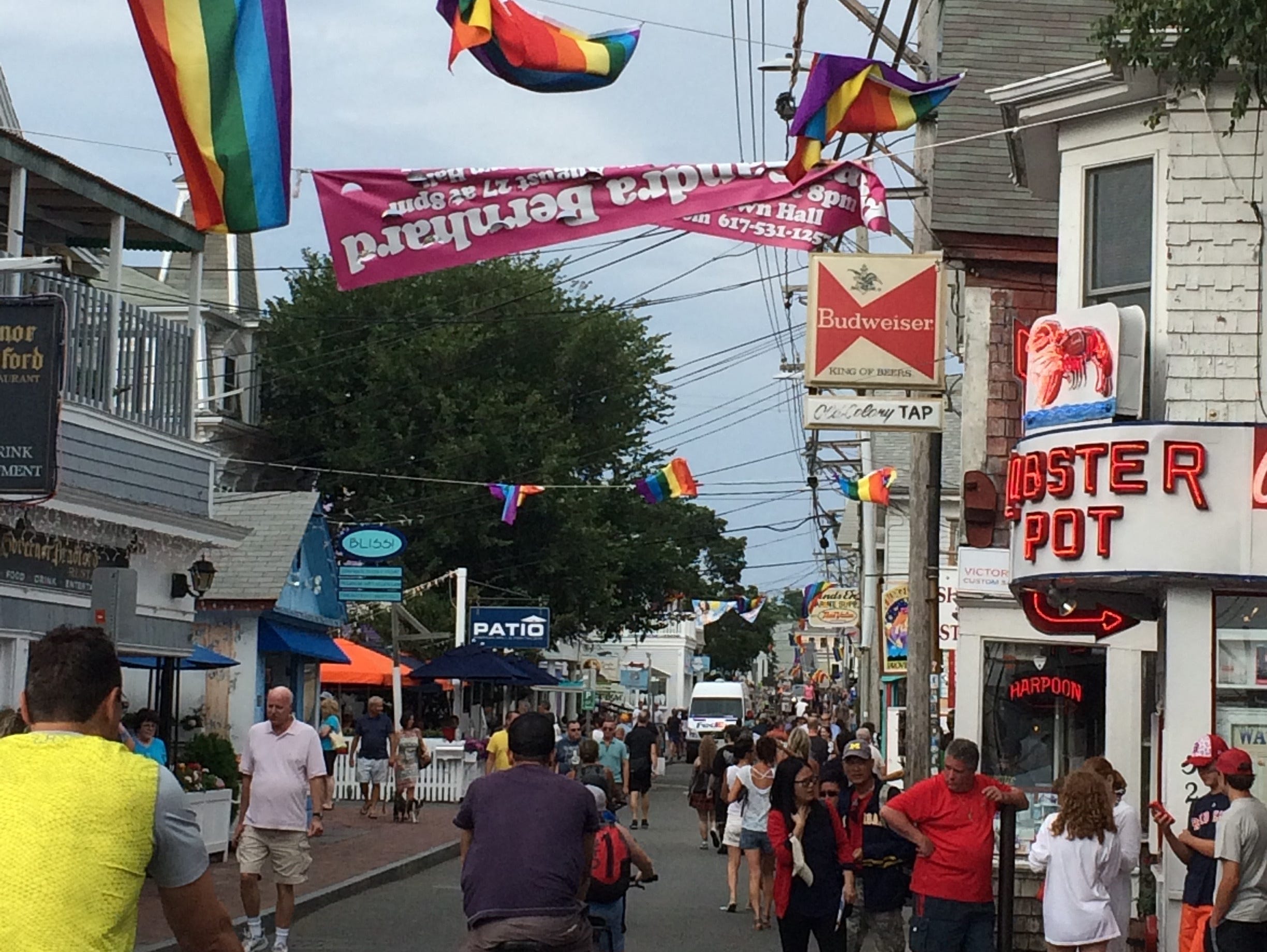 provincetown street with people, flags, crowds