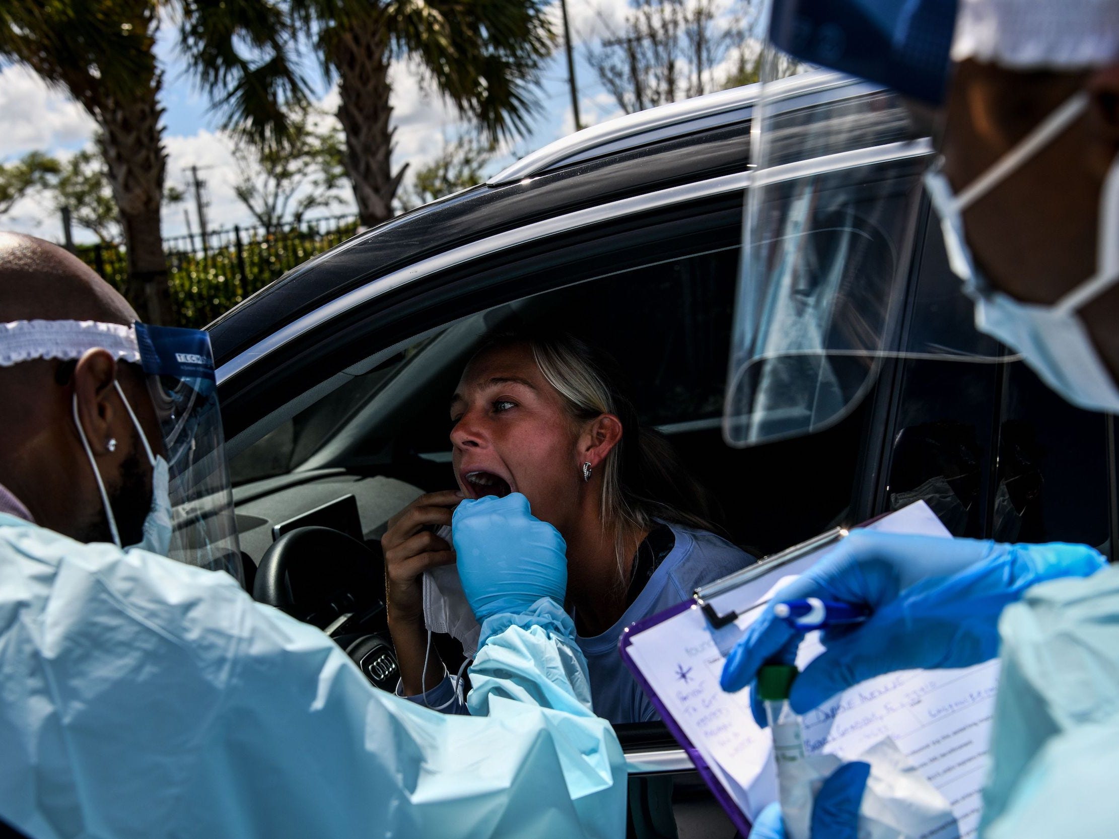 A Florida woman ireceives a coronavirus test in her car.