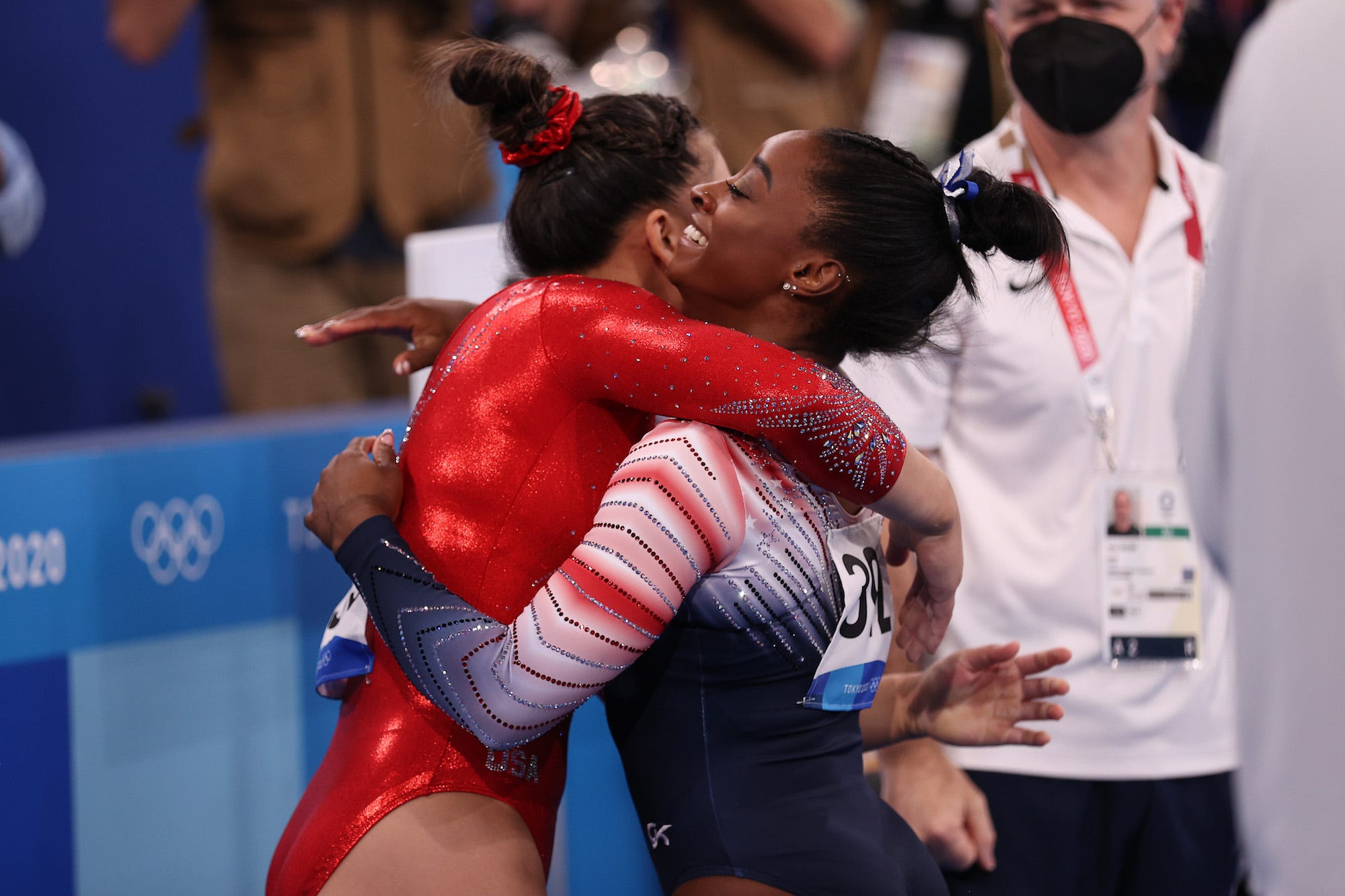 Simone Biles of Team United States embraces teammate Sunisa Lee during the Women's Balance Beam Final on day eleven of the Tokyo 2020 Olympic Games at Ariake Gymnastics Centre